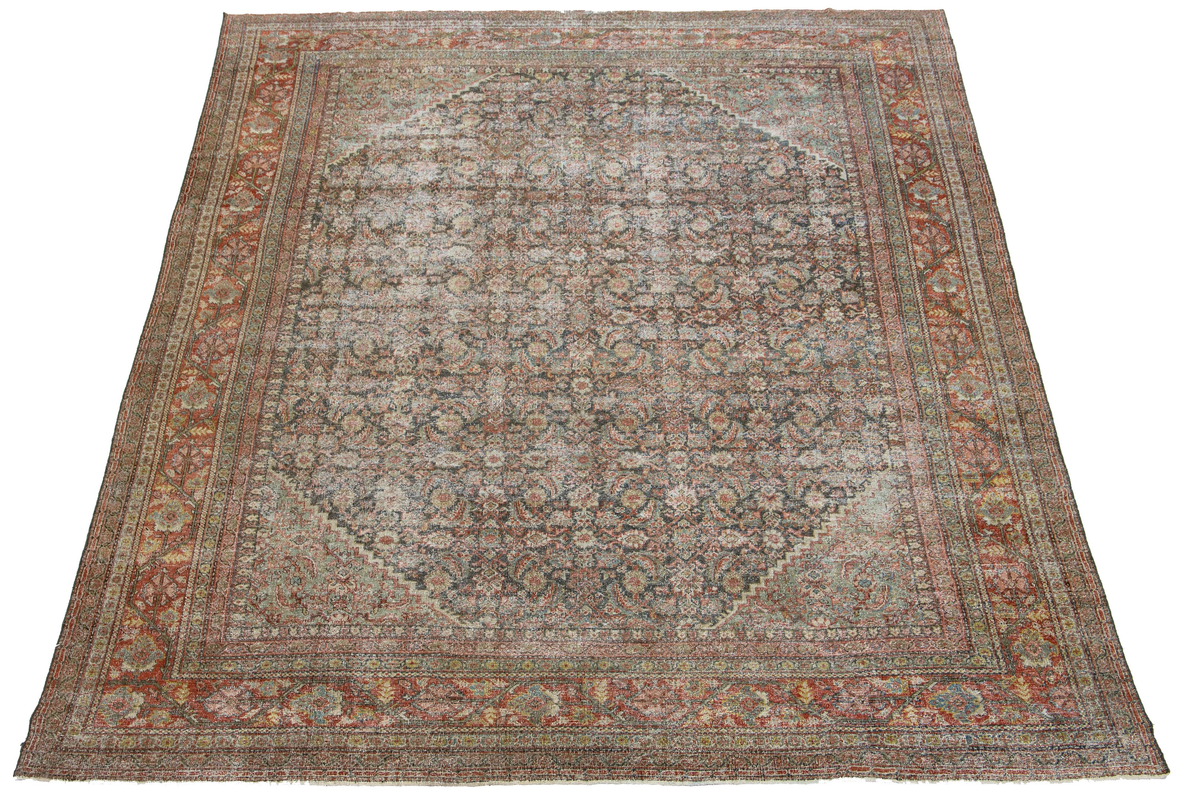 Beautiful antique hand-knotted Mahal wool rug with a blue field. It features terracotta, red, and yellow accents in an all-over floral design.

This rug measures 10'3