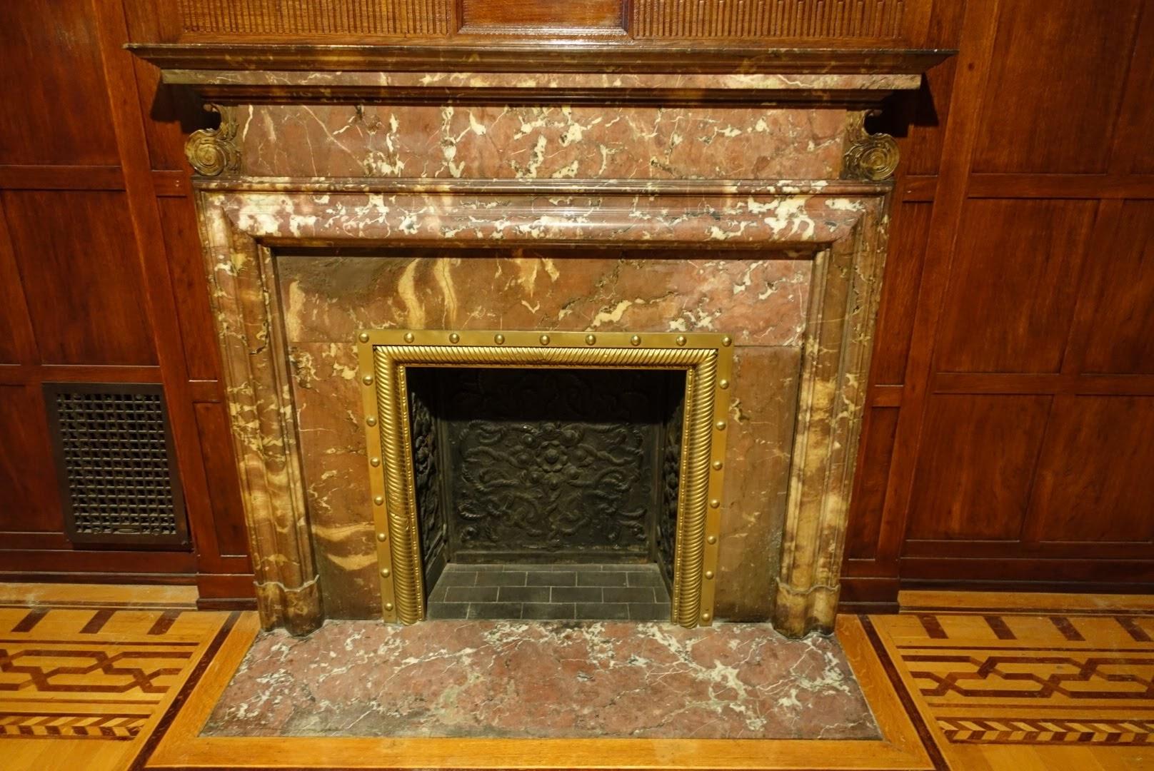 This Circa 1900 Royale bolection mantel features brown and dark red marble with cream colored veins. Included is the original brass firebox surround. This was original to an upper West side Manhattan estate on West 85th St in NYC. Hearth not