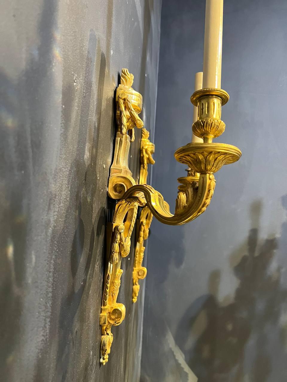 A circa 1900's Caldwell gilt bronze double lights sconces in style of Louis XVI. Original finish 