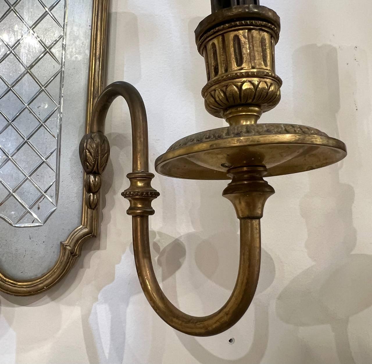 Antique a pair of circa 1910's Caldwell gilt bronze sconces with mirrored backplate 