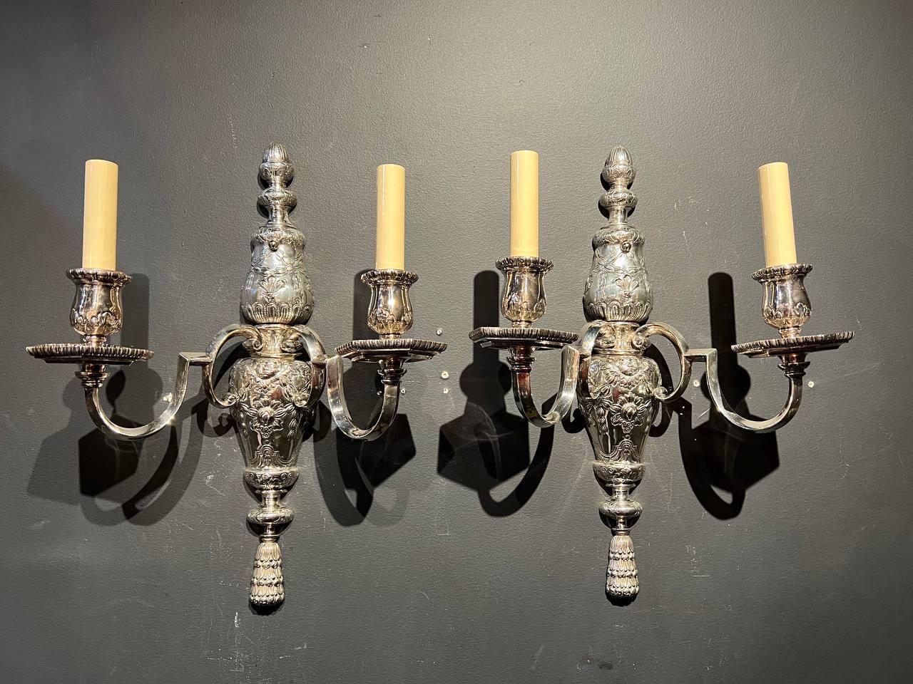 A pair of circa 1900’s Caldwell silver plated sconces with two lights