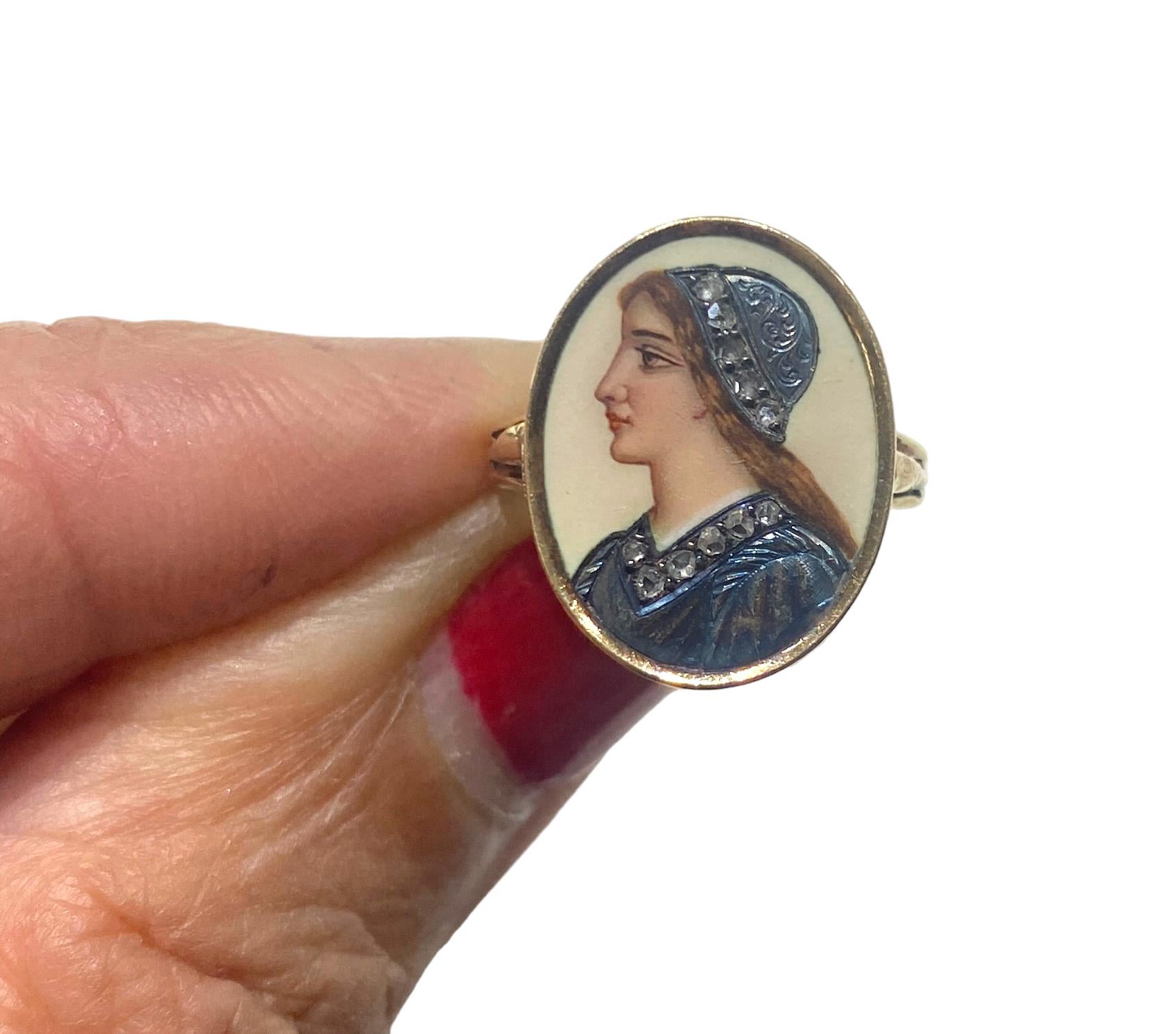 Hand Painted Renaissance cameo is a bezel set in a 14-karat yellow gold ring. The cameo is distinguished with brilliant colors and flicker of color, giving it a rich and unique finish. The total diameter of the ring is 17.71 mm x 15mm, and the shank