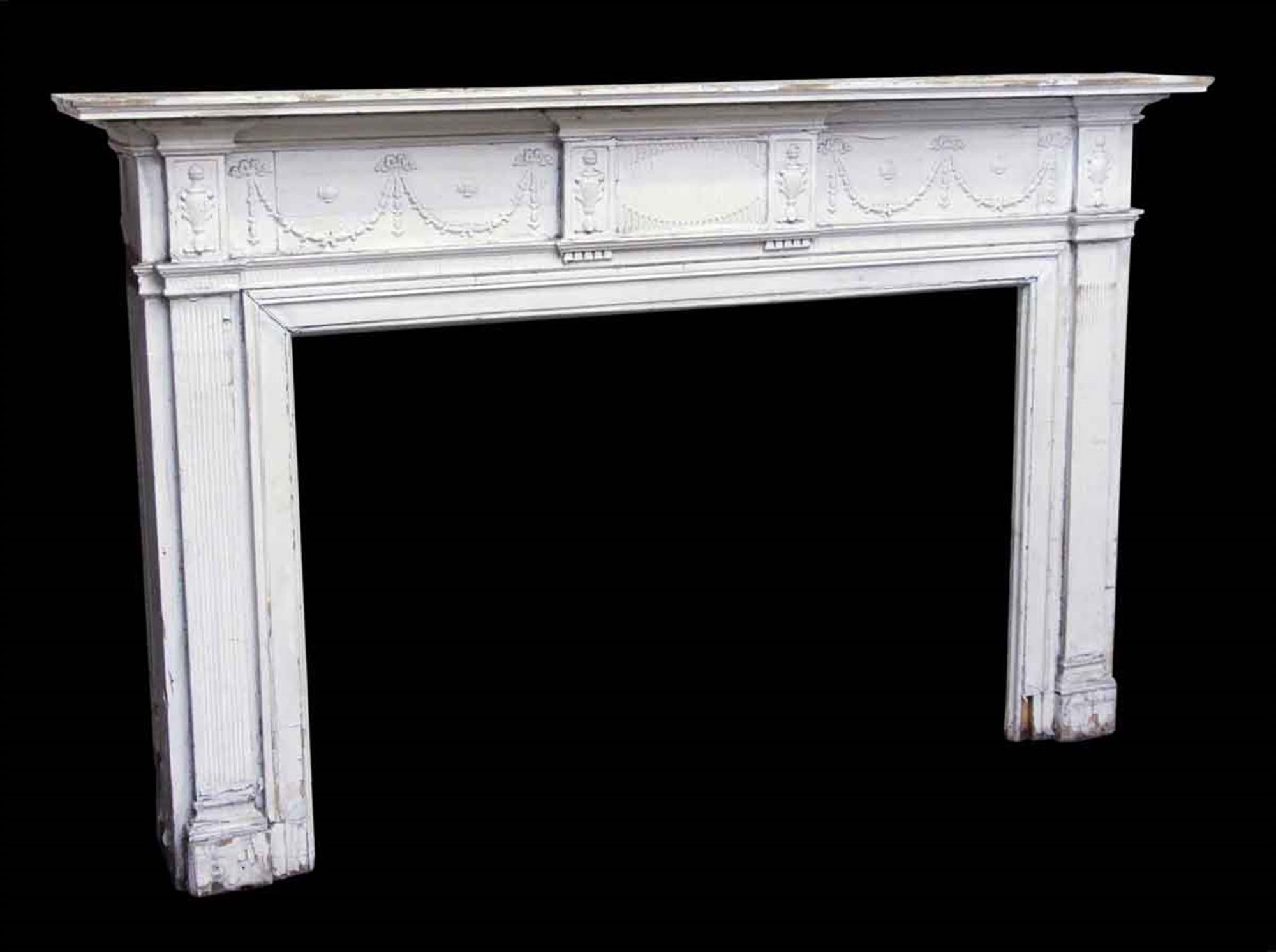 Federal style carved wood mantel with white crackle paint and garland design, circa 1900s. This can be seen at our 400 Gilligan St location in Scranton, PA.