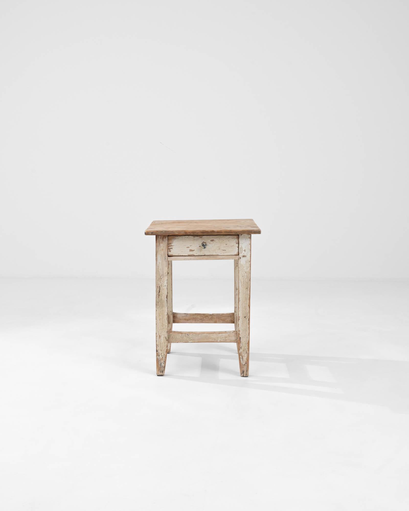 Introducing our exquisite 1900s Central European Wooden Stool, a charming piece that seamlessly blends functionality with vintage elegance. Crafted with meticulous attention to detail, this stool features straight legs that exude a classic appeal,