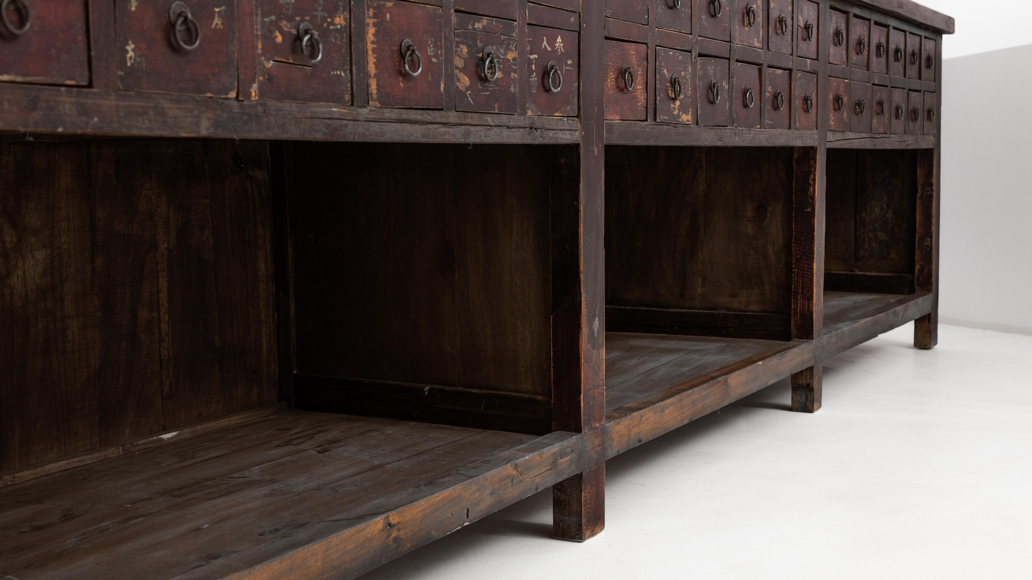 Introducing a distinctive piece from the 1900s, this Chinese Chest of Drawers with Original Patina stands as a testament to timeless craftsmanship. This unique chest features 36 small square drawers, arranged in three groups. Each group is paired