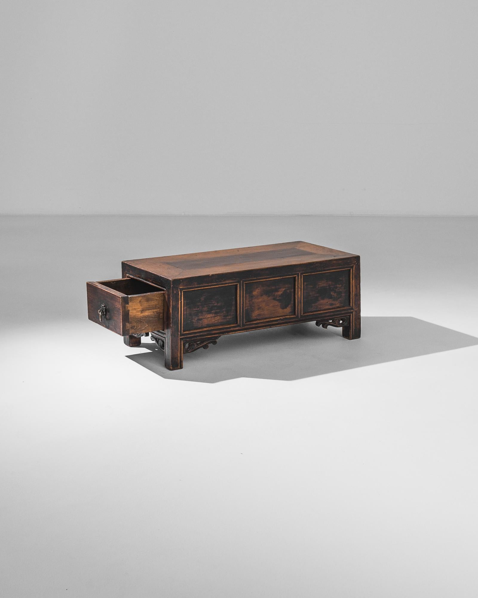 This exquisite 1900s Chinese wooden trunk is a remarkable piece of antique furniture that brings both functionality and a touch of history to your home. Featuring its original patina, this trunk showcases the rich, time-worn beauty of aged wood,