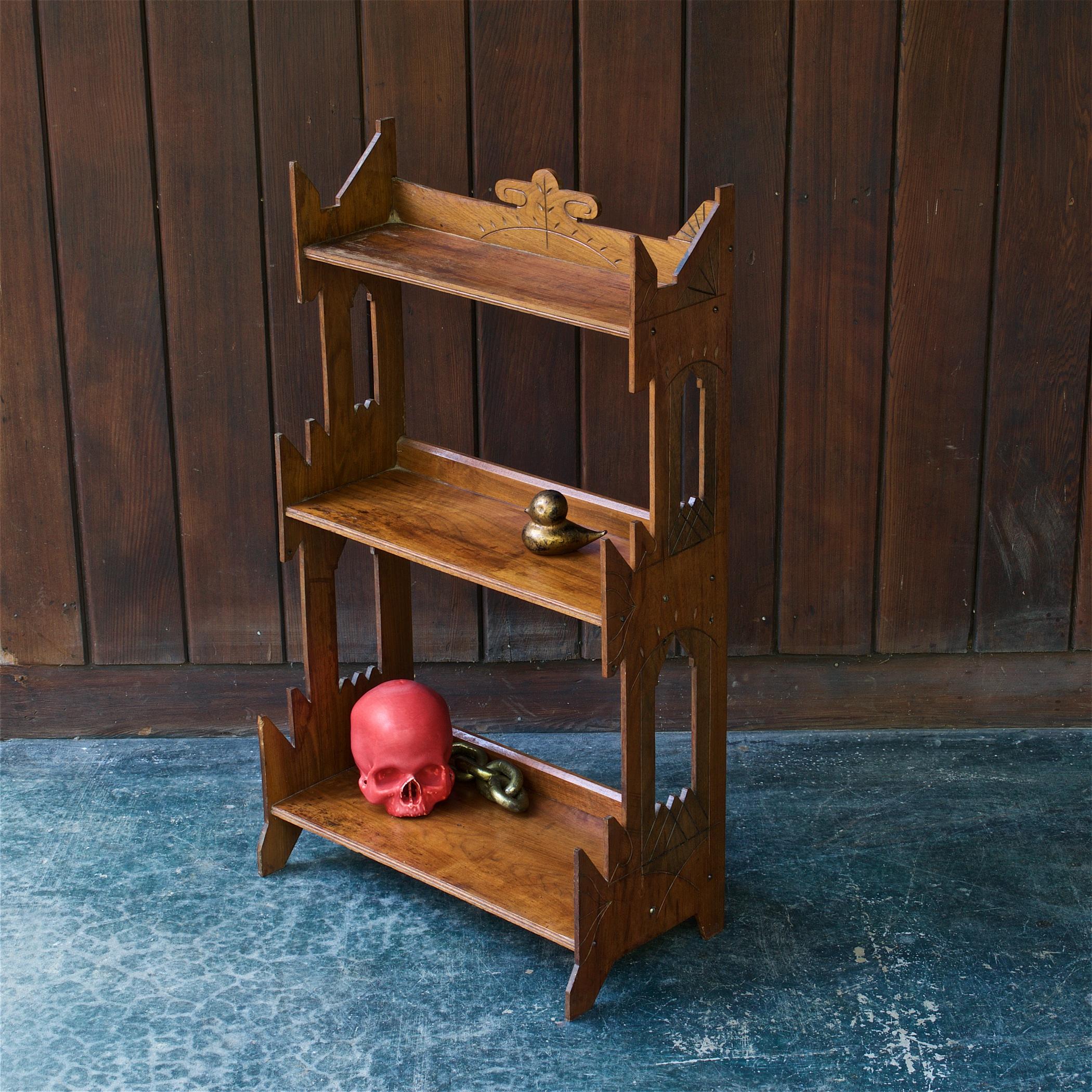 Warm, rustic and understated ornate carved walnut plywood paneled shelf. Made for light duty; paperback or small collectibles. Missing a small triangular piece on top back left panel edge, hard to notice, the asymmetry.

Measures: W 21 x D 11 x H