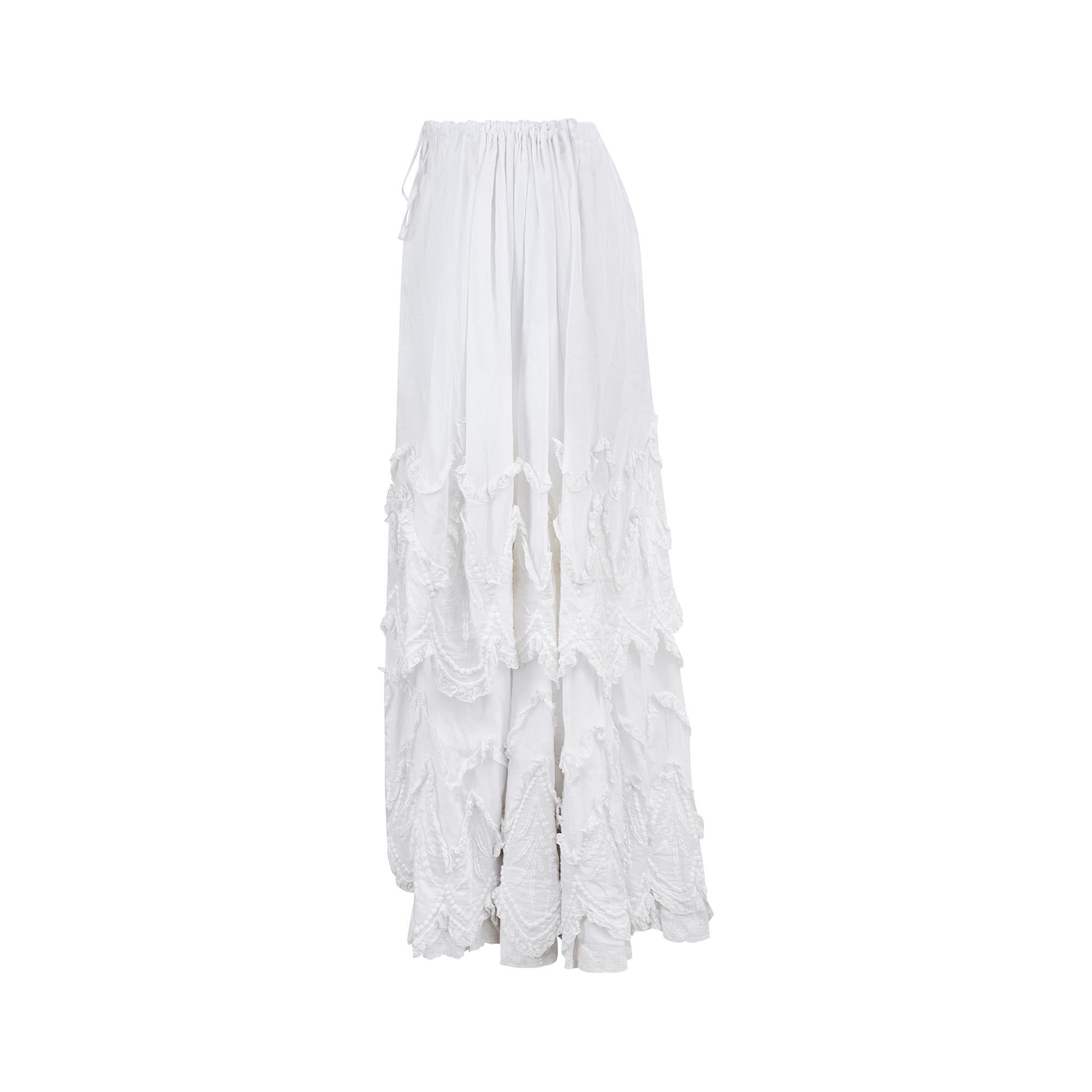 Outstanding Edwardian triple tiered skirt made entirely by hand in the early 1900s. An outwardly romantic piece, it is tailored from layer-upon-layer of breezy white mousseline cotton and trimmed with lace along the bottom hems. The short outer