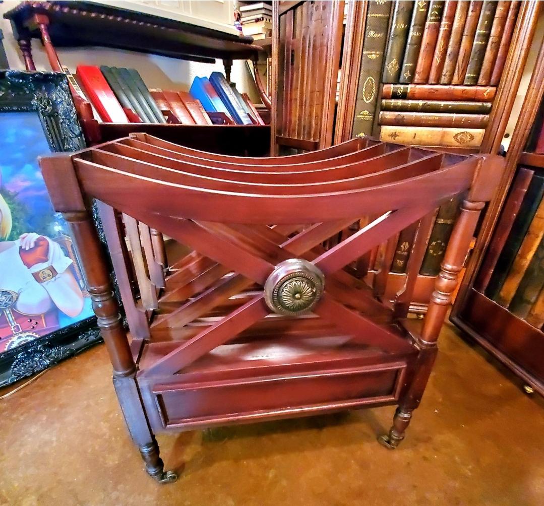 Antique English Mahogany Canterbury magazine rack.
Four spacious divisions over a good sized single dove tail drawer with original brass pulls. Original, functional brass casters.,
This wasn't made by modern day machines, you can see it in the