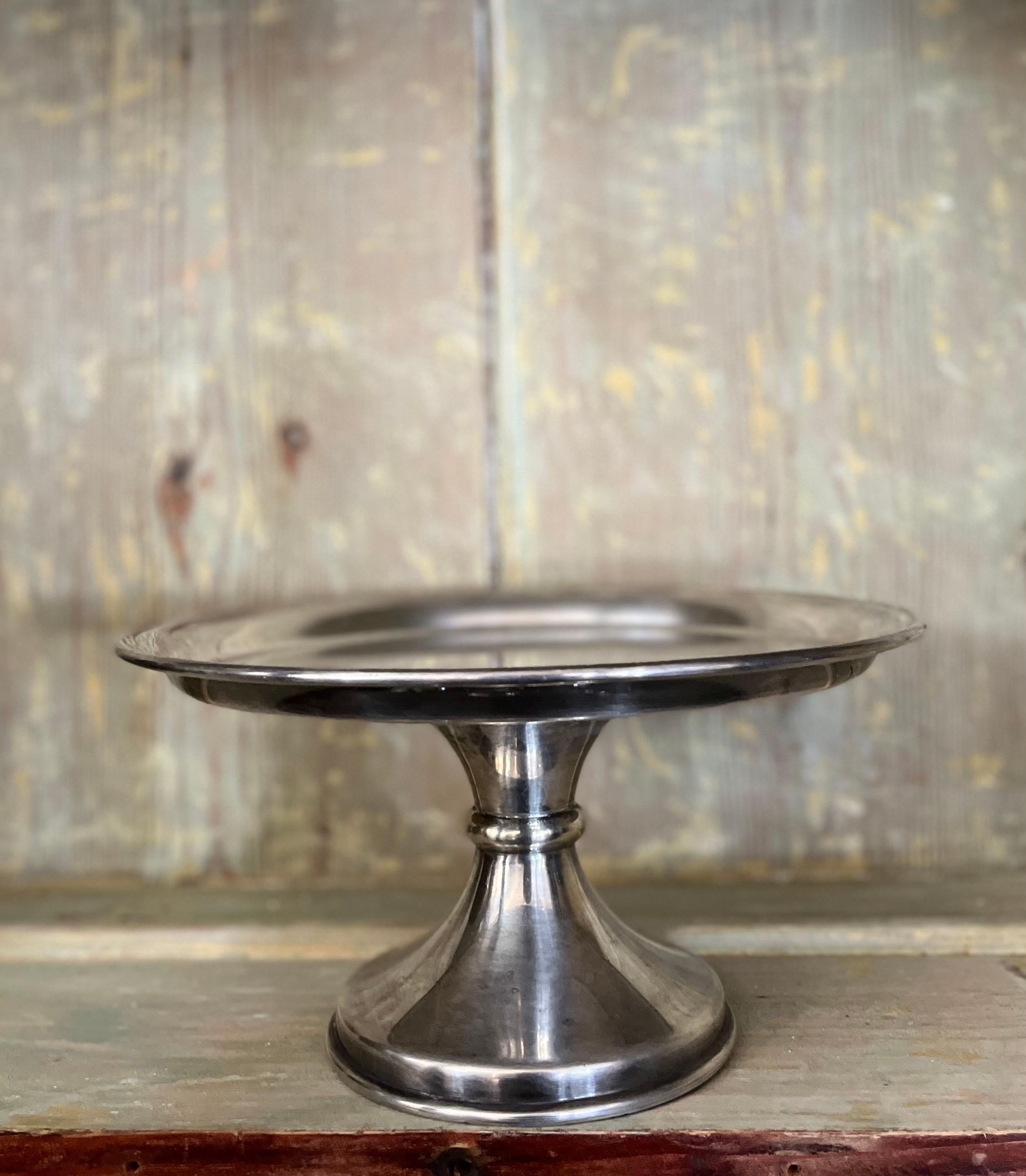 Victorian silverplate cake stand by Alex R. Clark and Co. With simple, traditional lines, the stand makes an interesting sculptural statement when used as a decorative accent in a shelf or table-scape, yet would work just as well as a display mount