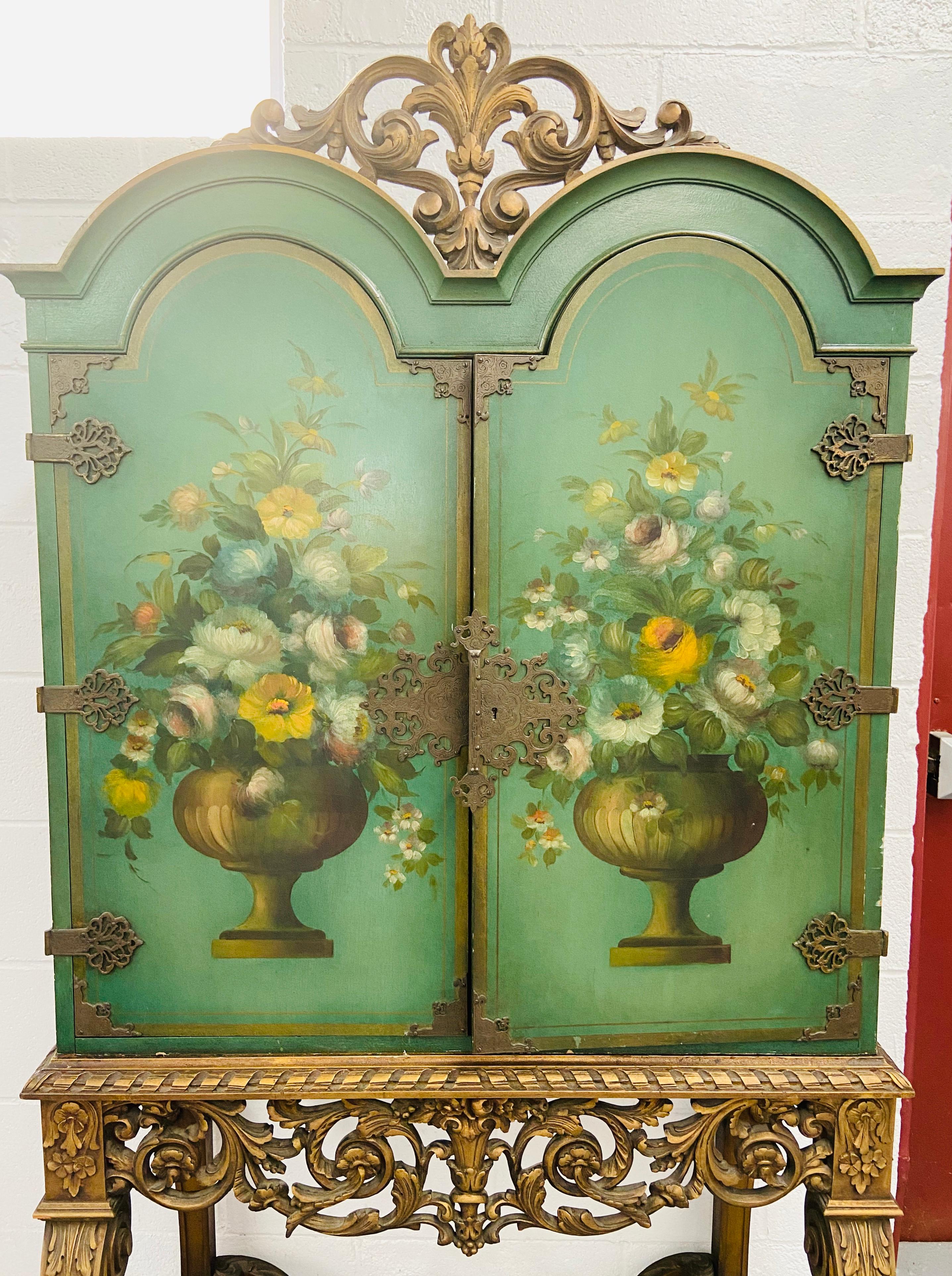 1900s English Paint Decorated Radio Cabinet Cupboard 
This gorgeous English two door floral paint and gilt decorated radio cabinet
features refined floral design on a green background. the radio cabinet has multiple storage shelves and a fitted room