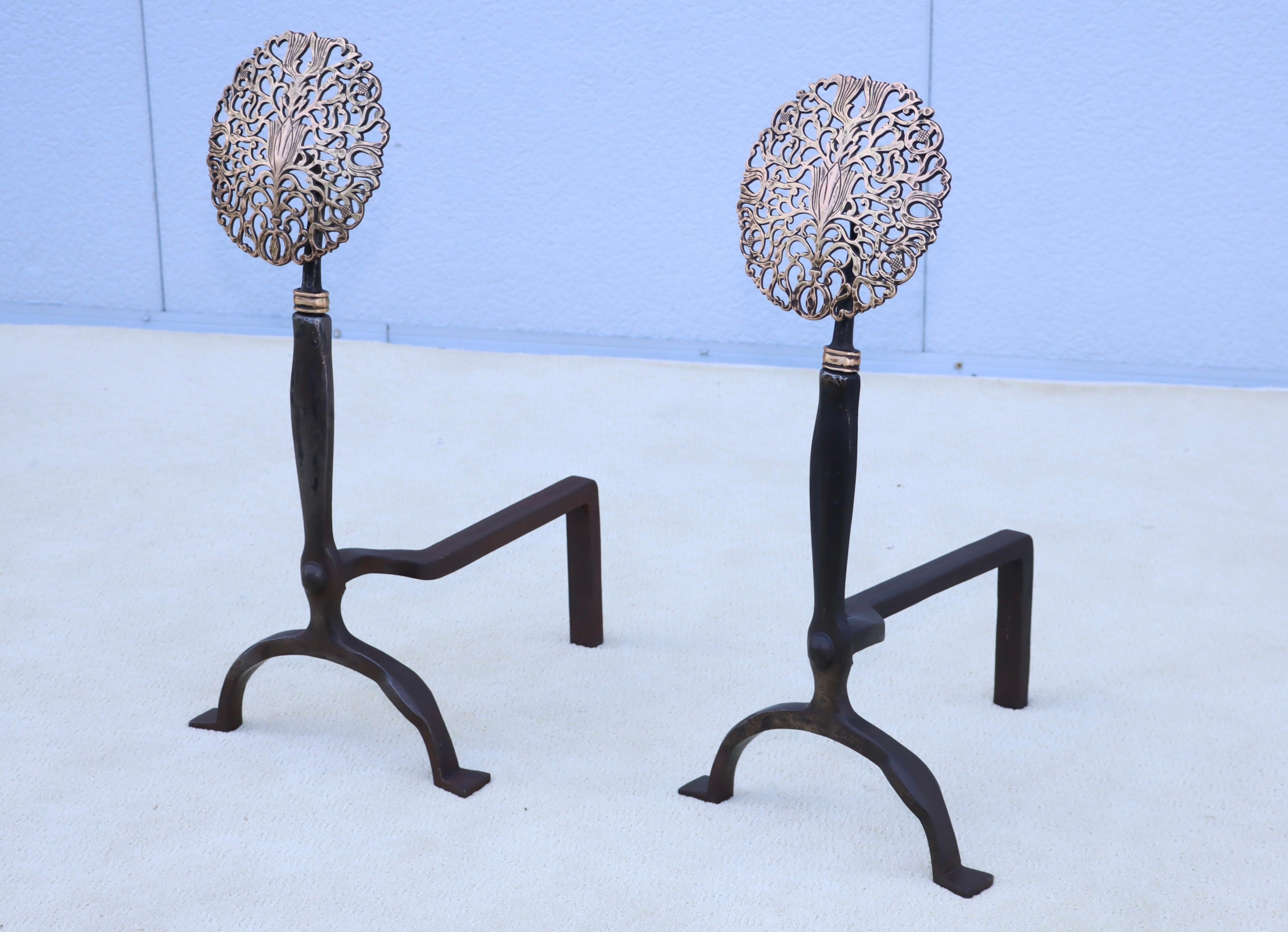 1900's brass and iron Medallion andiron in the style of Ernest Gimson, in vintage condition with some wear and patina due to age and use, they have been lightly hand polished.