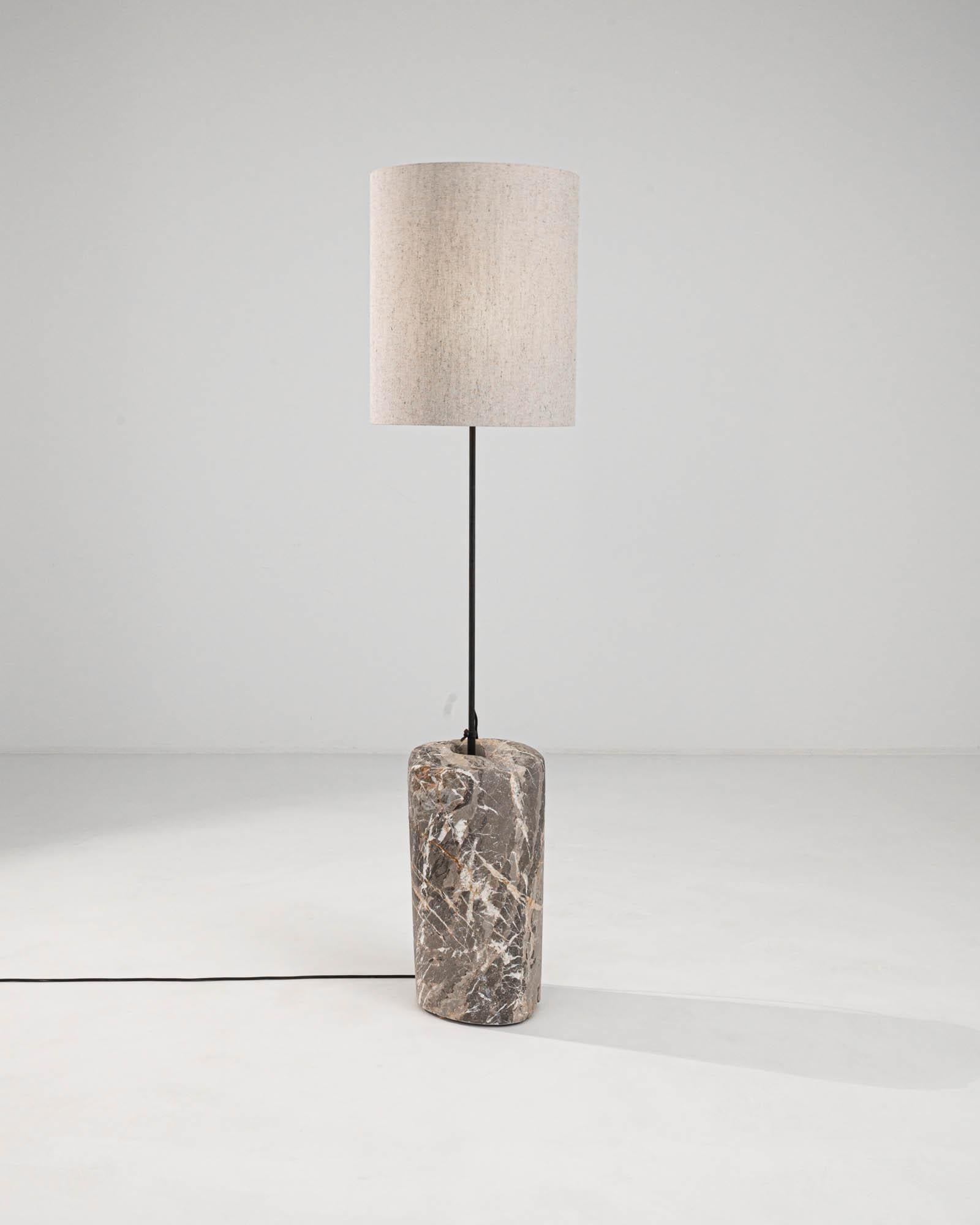 Illuminate your space with the timeless elegance of the 1900s European Marble & Metal Floor Lamp. A celebration of classic style and sophistication, this floor lamp features a genuine marble base, whose unique patterns and warm, earthy tones add an