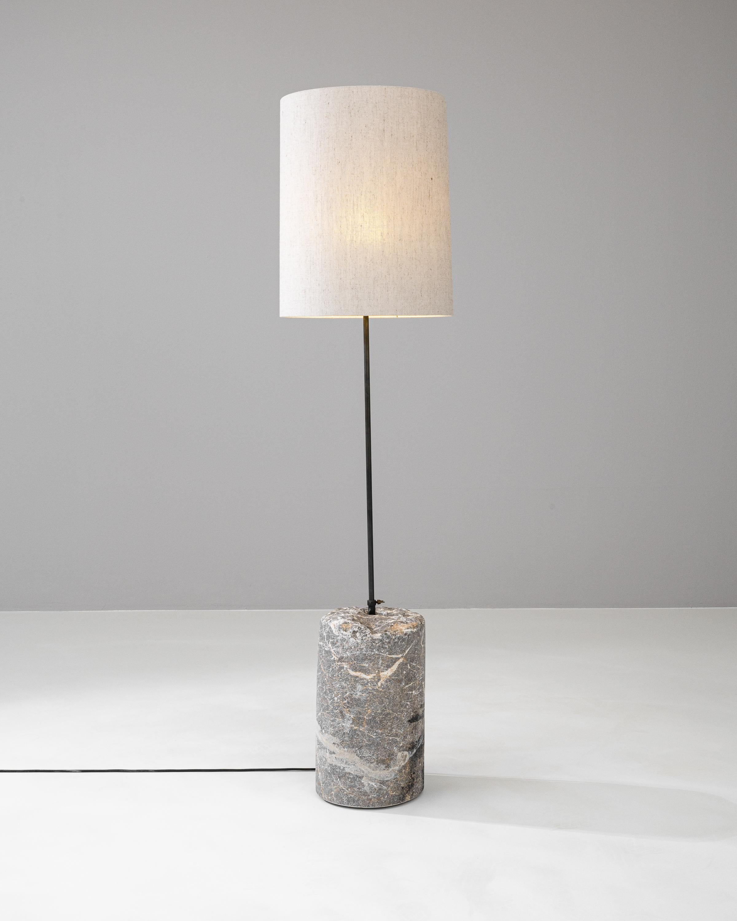 Illuminate your space with the timeless elegance of the 1900s European Marble & Metal Floor Lamp. A celebration of classic style and sophistication, this floor lamp features a genuine marble base, whose unique patterns and grey tones add an organic
