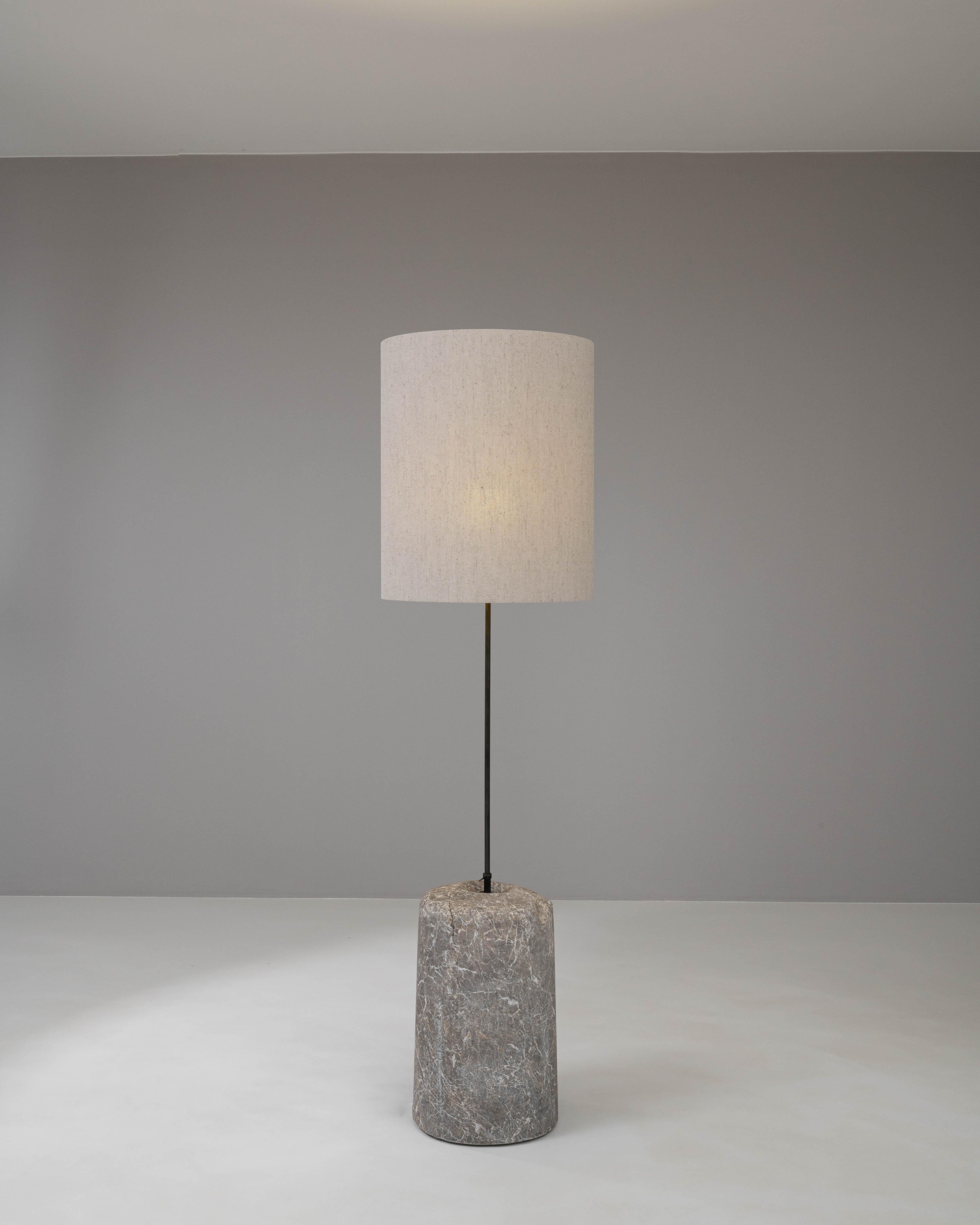 Anchor your space with the solidity and sophistication of this 1900s European floor lamp, a fusion of natural marble and sleek metal. The robust, cylindrical marble base is a statement of nature's artistry, with intricate veins and textures that