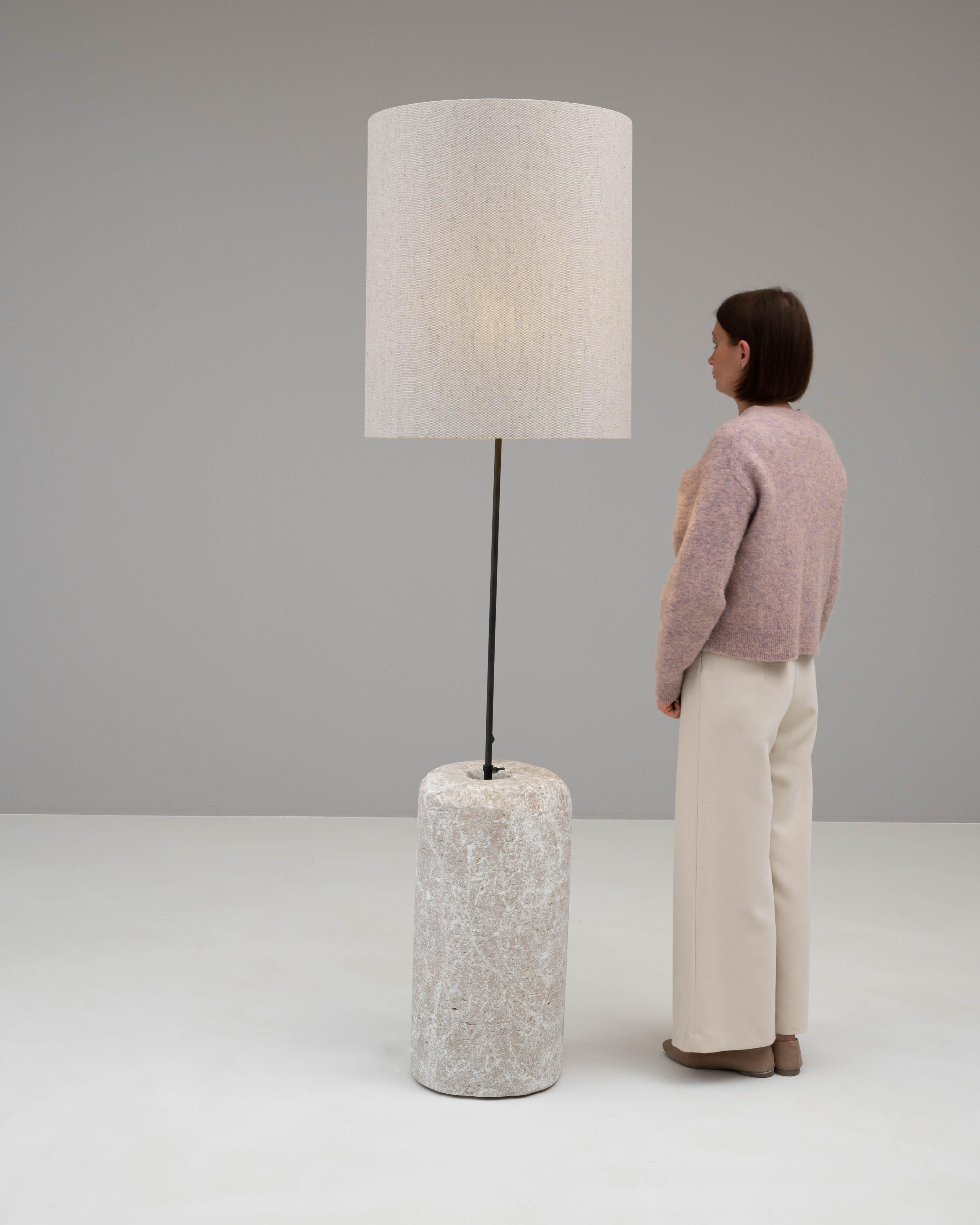 This 1900s European floor lamp beautifully marries the rugged texture of natural marble with the industrial sleekness of metal. The lamp's base, robust in form and rich with the organic patterns unique to marble, is a solid foundation that exudes