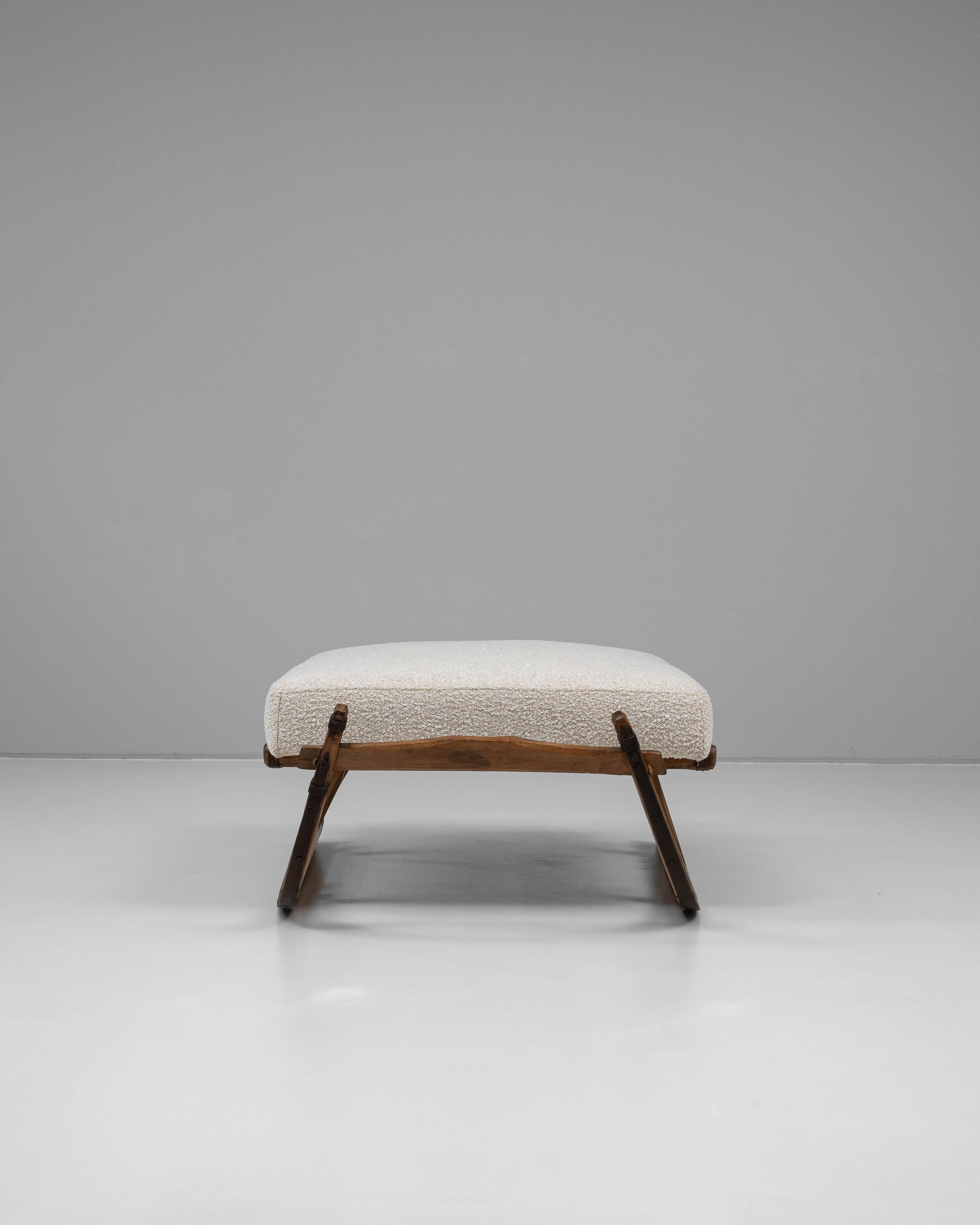 This 1900s European wooden bench with upholstered seat combines rustic charm with a sculptural silhouette. The frame, crafted from solid wood, features gracefully curved sled-style supports reminiscent of traditional sleigh designs, complete with