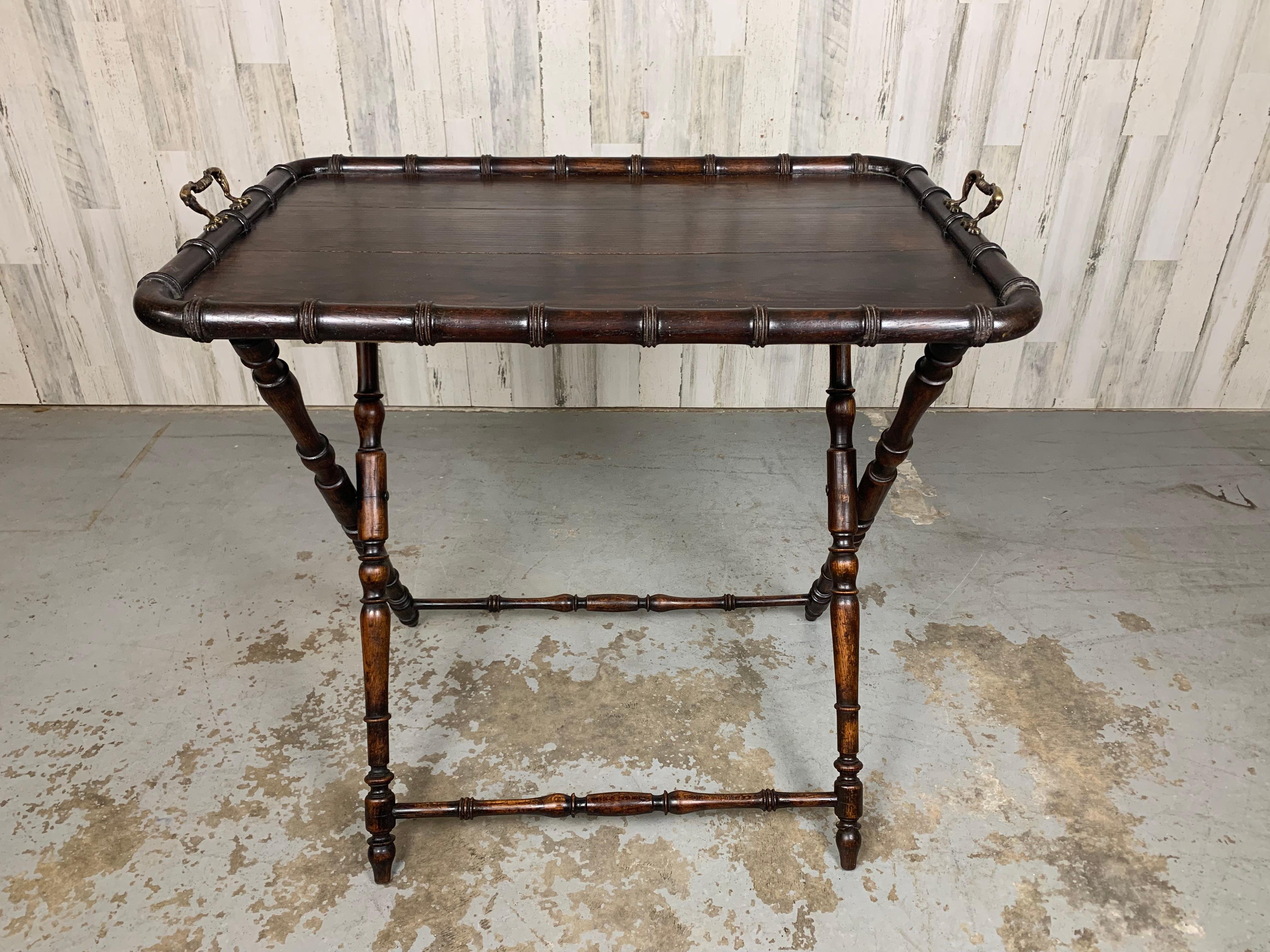 Faux Bamboo butler tray with ornate brass handles and folding stand. Circa 1900 made in England for garden parties and entertainment.