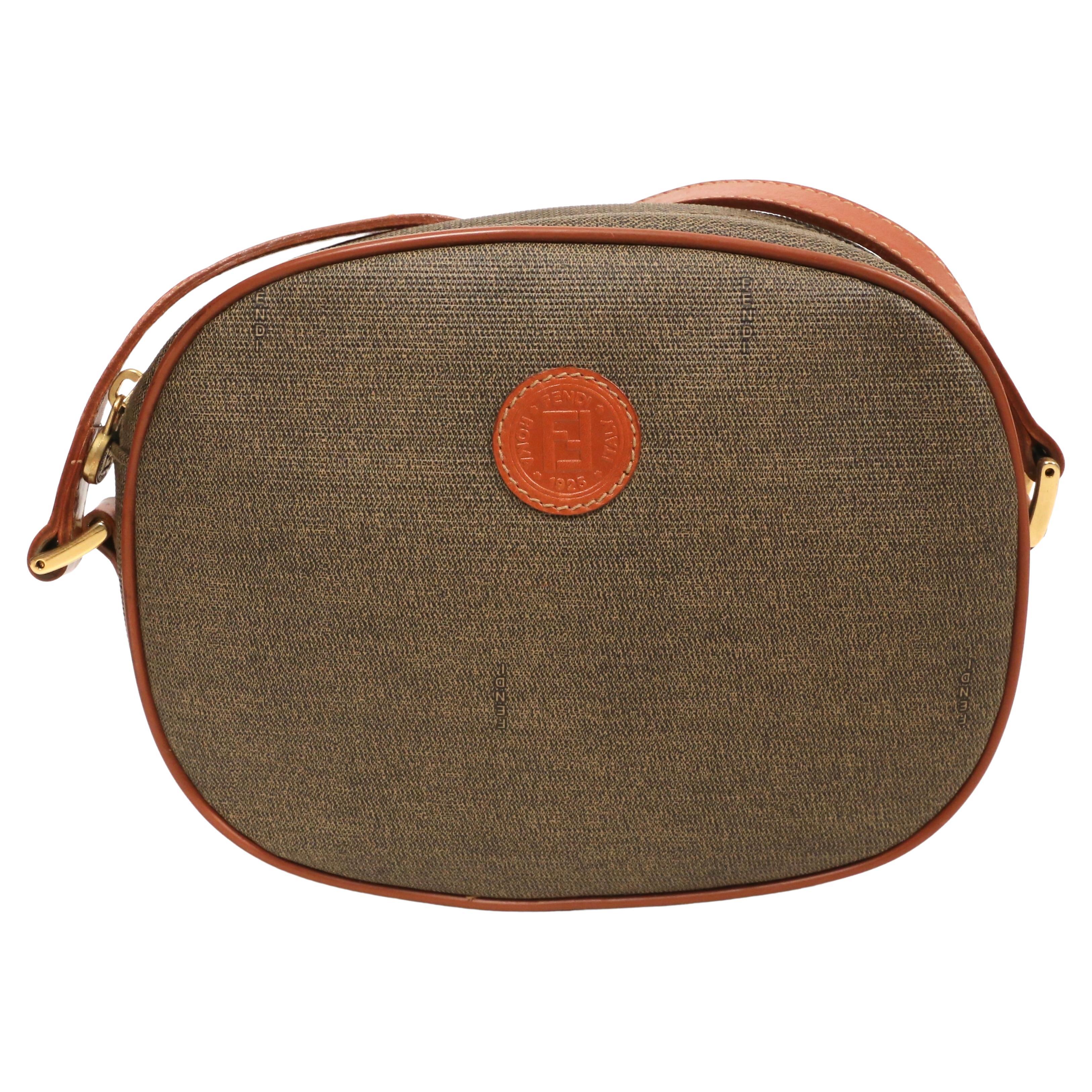 Brown 1990's FENDI oval crossbody bag with logo print and leather trim For Sale