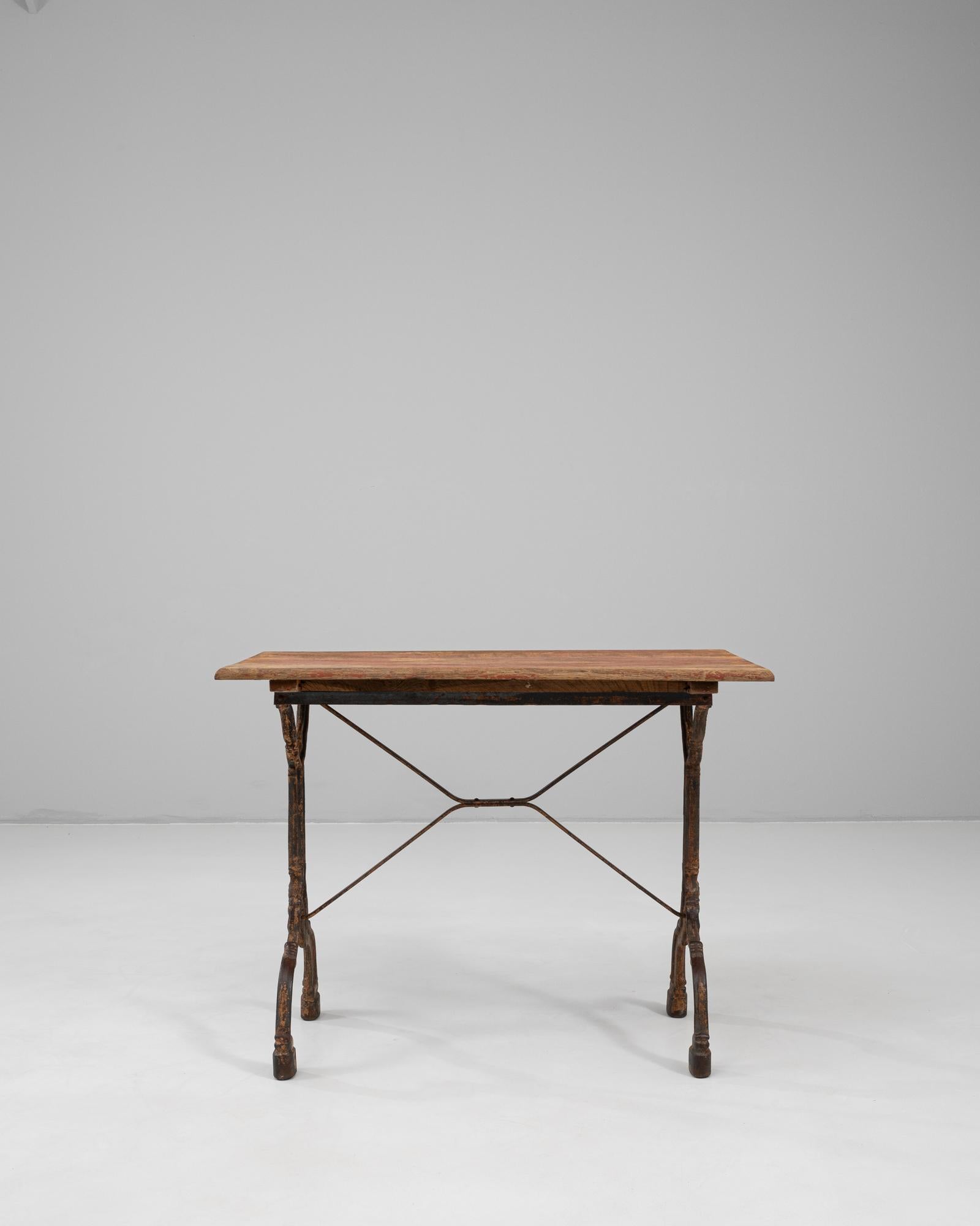 This 1900s French bistro table beautifully combines industrial strength with timeless charm. Featuring a cast iron base with intricate detailing and a cross-stretcher for added stability, the design reflects the craftsmanship and durability typical