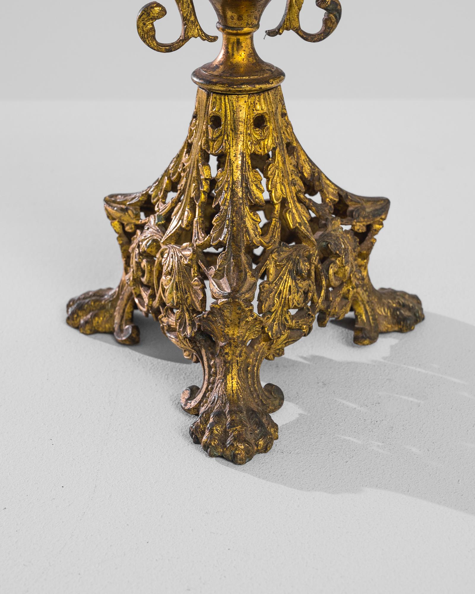 Indulge in the opulence of the 1900s with this French Brass Candlestick. Crafted in the 19th century, this gilt-metal five-light candelabra exudes the grandeur of the Baroque style. It is gracefully cast as a bouquet of lilies, their stems rising