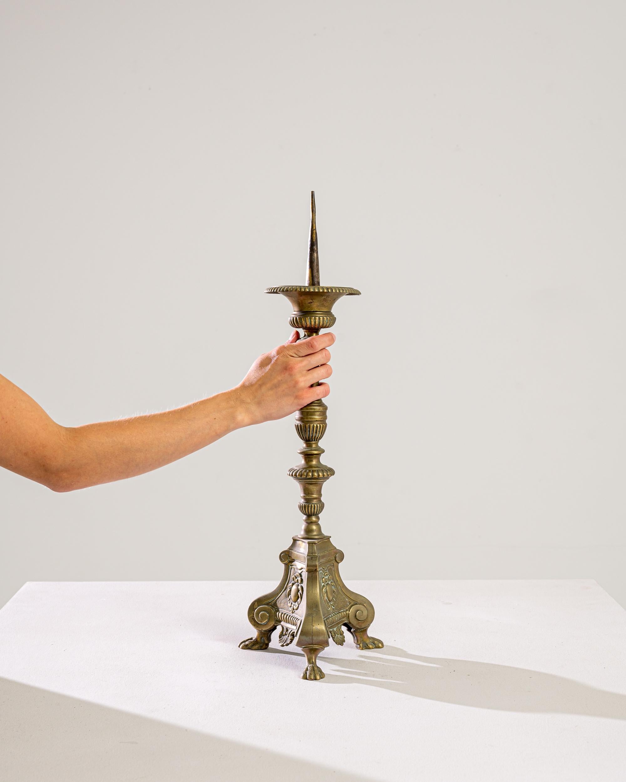 Step into a world of timeless elegance with this exquisite 1900s French Brass Candlestick, a treasured piece from a bygone era that whispers tales of old-world charm and sophisticated dinners by candlelight. Standing proud with a height that