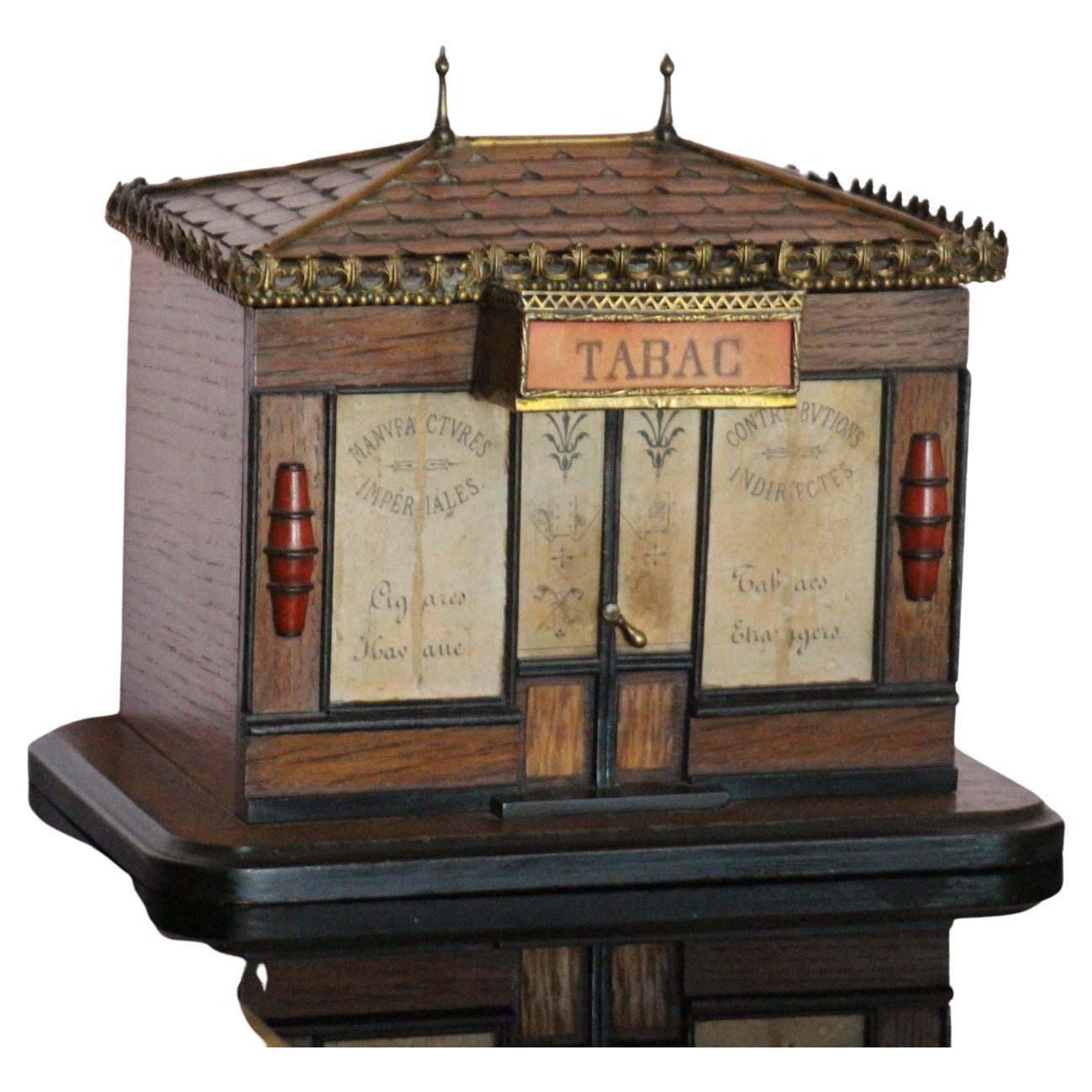 This amazing cigar box modeled as a French tobacco store features 2 windows and a central door that are all decorated.On the top, where there is the 