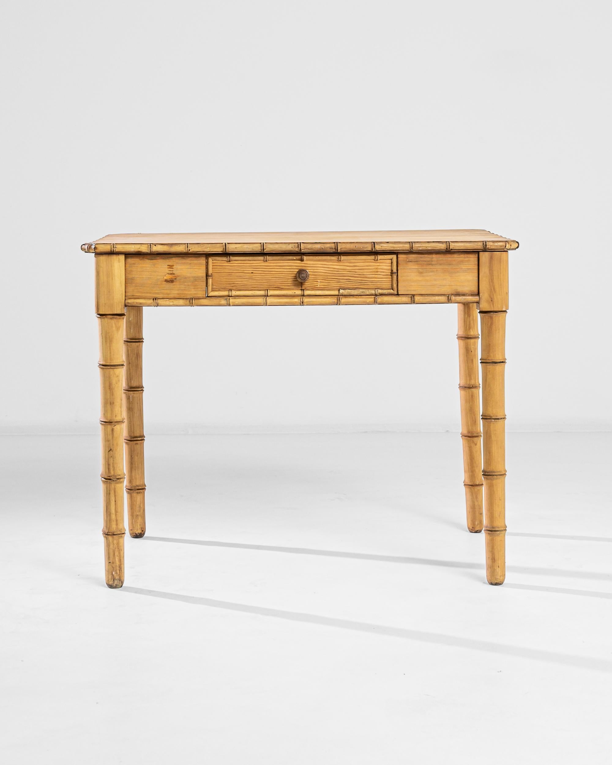 This wooden occasional table was produced in France, circa 1900. A low bamboo and golden wheat wood table with a perfect tone match, this occasional table features a practical front drawer adorned with a darker wooden pull and a subtle patina. The