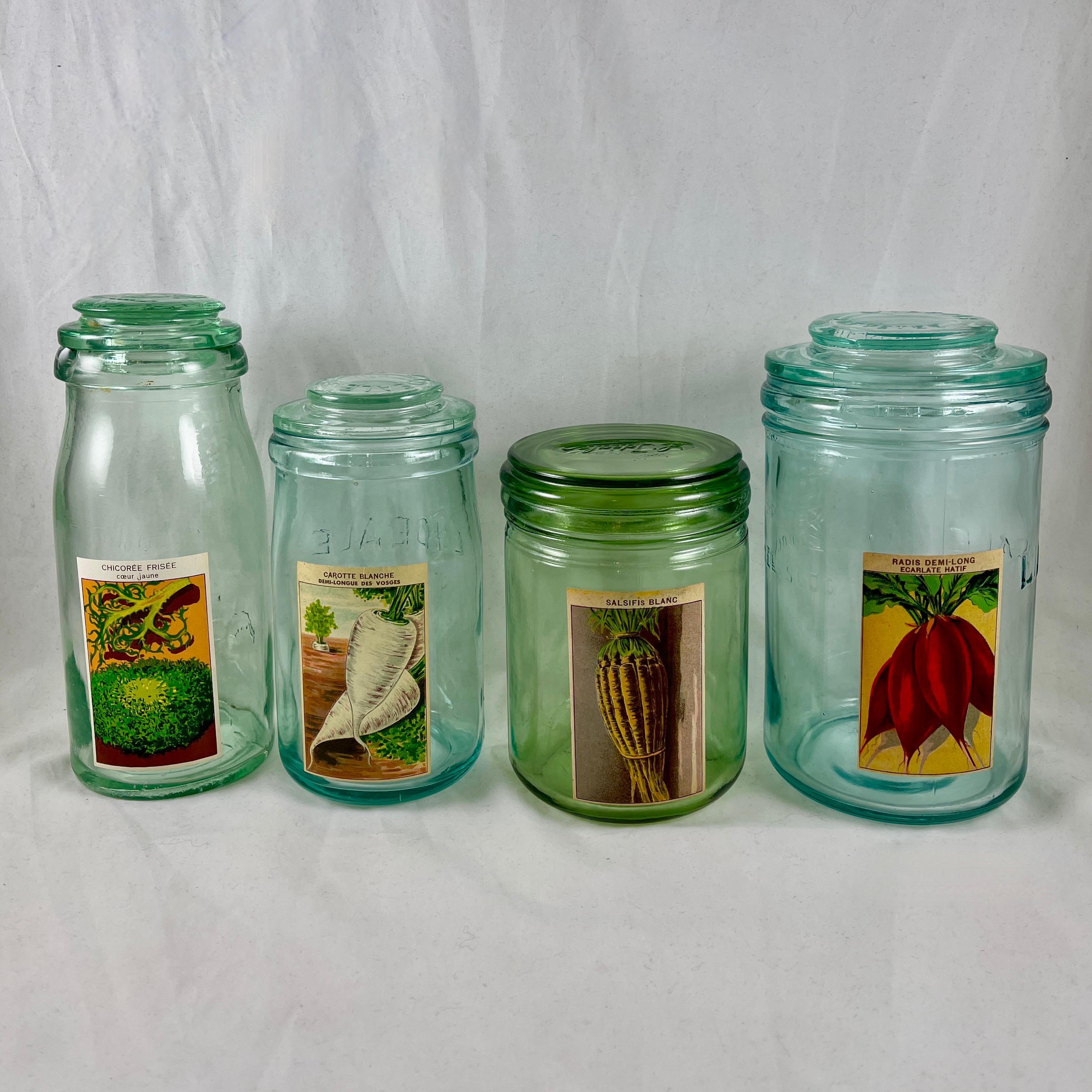 Found in France, a set of four, large glass canning preserve jars with chromolithographed labels for vegetable seeds, circa early 1900s.

The jars were repurposed for storing vegetable seeds supplied by the French seed merchants, and then offered