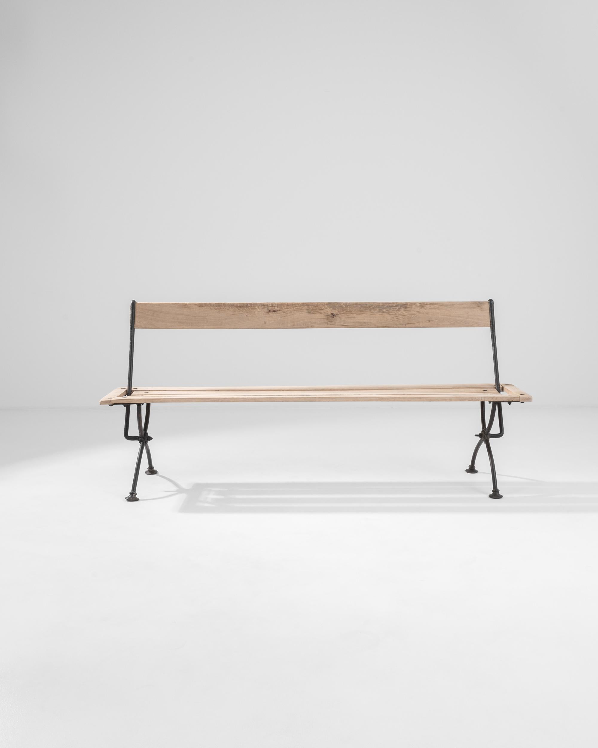 A novel design defines his intriguing rustic piece from France circa 1900. This charming bench, in oak and wrought iron, beams with rustic and mechanical appeal– toggling its orientation back and forth with a clever adjustable back. Natural wood