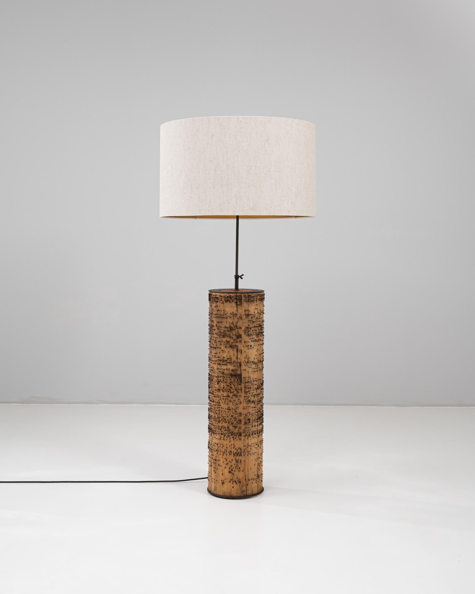 This 1900s French roller organ lamp transforms a historic mechanical artifact into a striking piece of functional art. The cylindrical wooden base—originally part of a roller organ mechanism—is punctuated with hundreds of iron pins that once