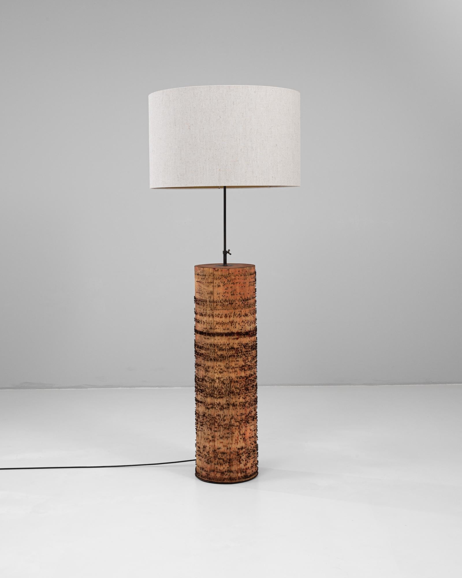 This 1900s French roller organ lamp transforms a historic mechanical artifact into a striking piece of functional art. The cylindrical wooden base—originally part of a roller organ mechanism—is punctuated with hundreds of iron pins that once