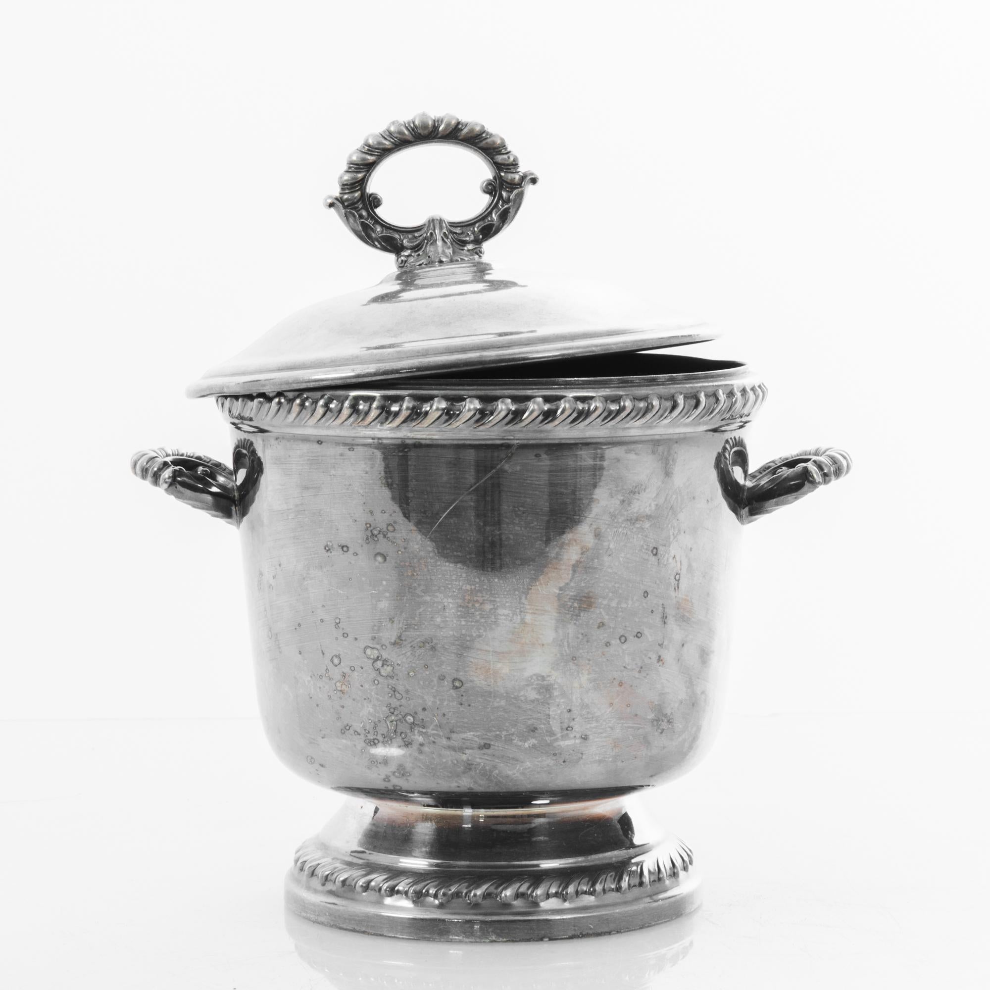 From before the era of refrigeration, this was an essential appliance for every party or quiet evening refreshment. With a beautiful aged finish and distinctive ornamental shape characteristic of turn of the century silversmiths. This functional