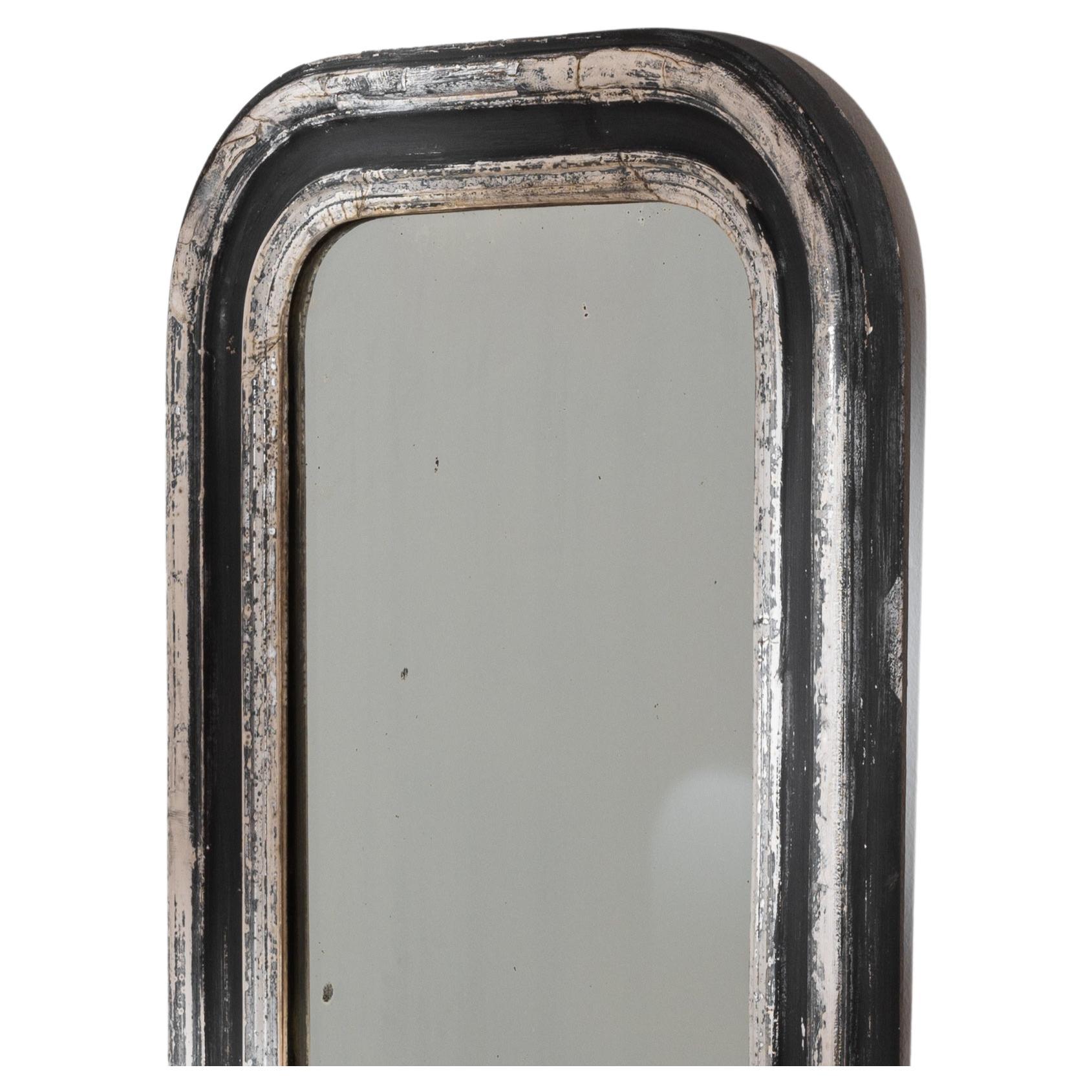 Immerse yourself in the allure of the 1900s with this French Wood Patinated Mirror, a harmonious blend of sophistication and timeless design. The mirror features a distinctive border arrangement, with two silver borders gracefully embracing a
