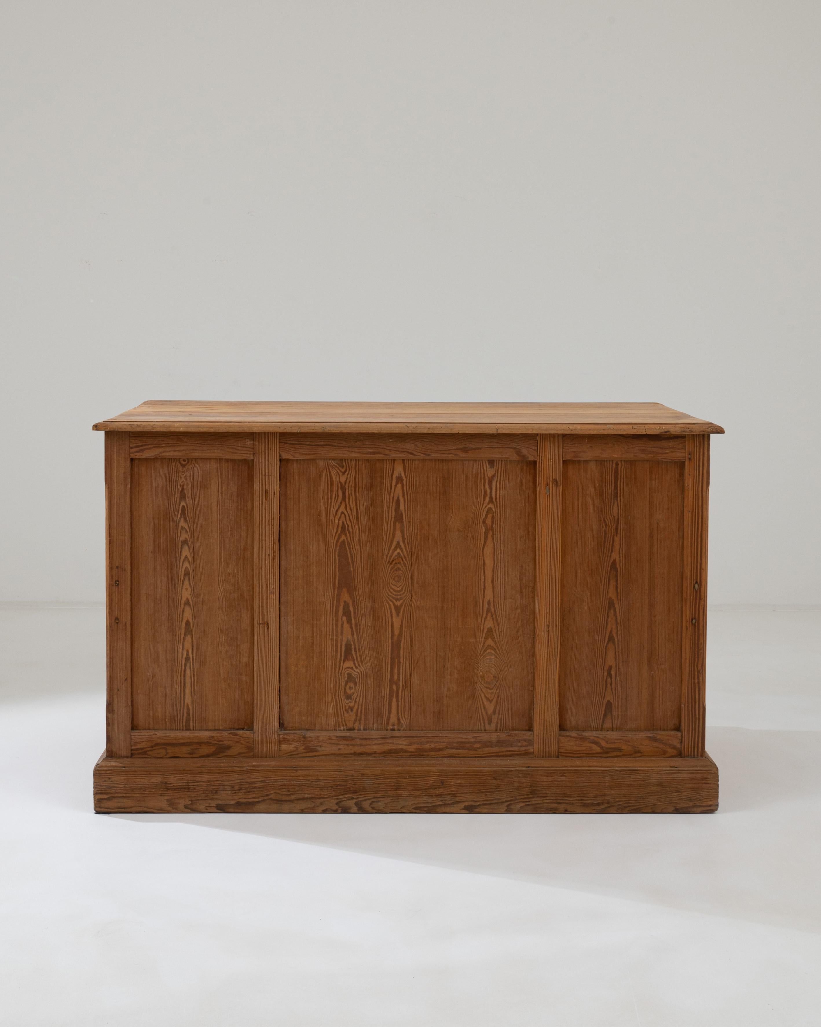 A wooden desk created in 1900s France. Unassuming and sturdily composed, this classic writing desk offers a calming sense of purpose and thoughtfully composed design. The seamlessly joined wood, which has been only lightly brushed by time, forms a
