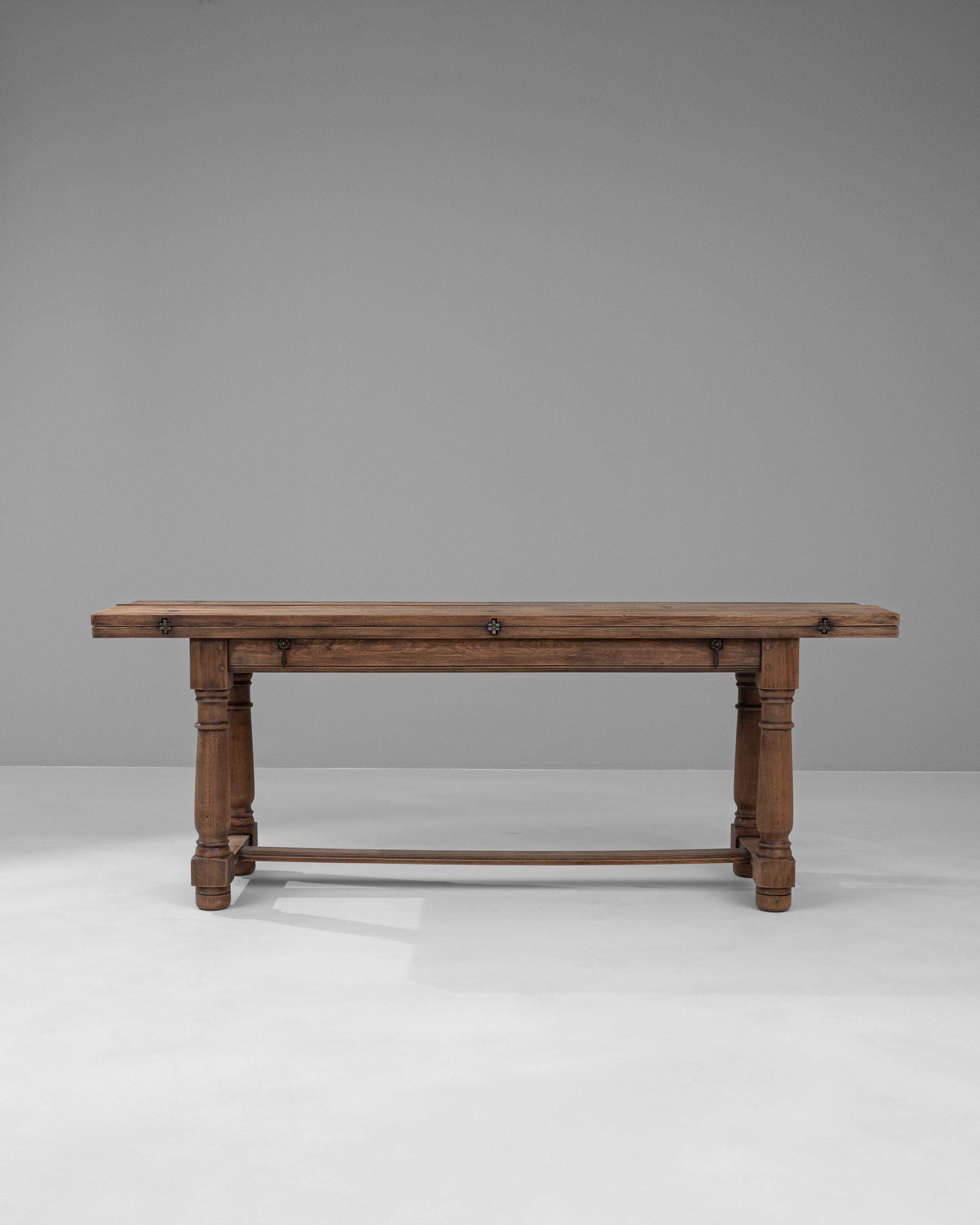 Step into a world of timeless elegance with our 1900s French Wooden Folding Table. Meticulously crafted from rich, robust wood, this table exemplifies classic French design with its intricate carved legs and rustic charm. Its unique folding