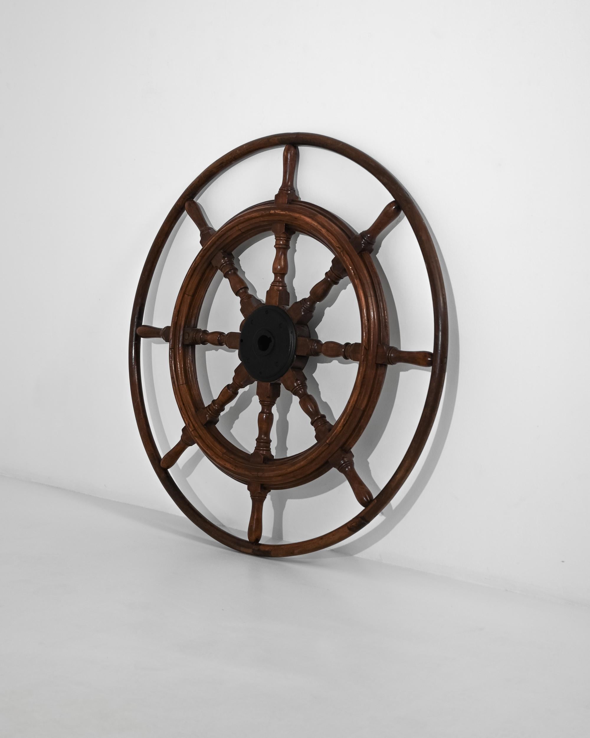 Capture the spirit of nautical history with this magnificent 1900s French wooden ship steering wheel. Crafted with exceptional attention to detail, this large, robust wheel showcases the expert craftsmanship of early 20th-century maritime design.
