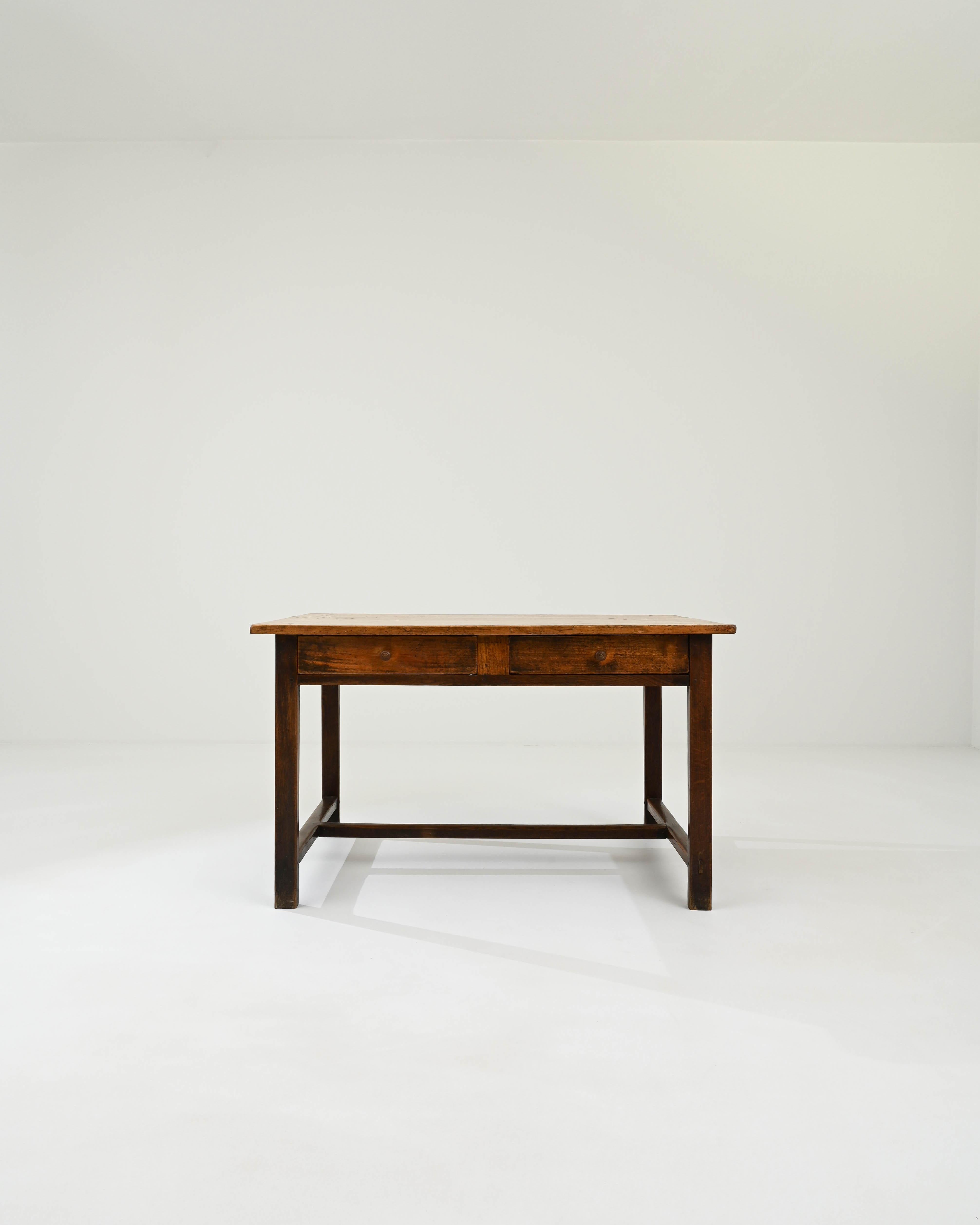 A wooden side table created in 1900s France. Simple, unassuming, and possessing a quiet disposition, the elegantly minimal construction of this side table allows the beauty of its natural materials to shine. Mortise and tenon joinery, an understated