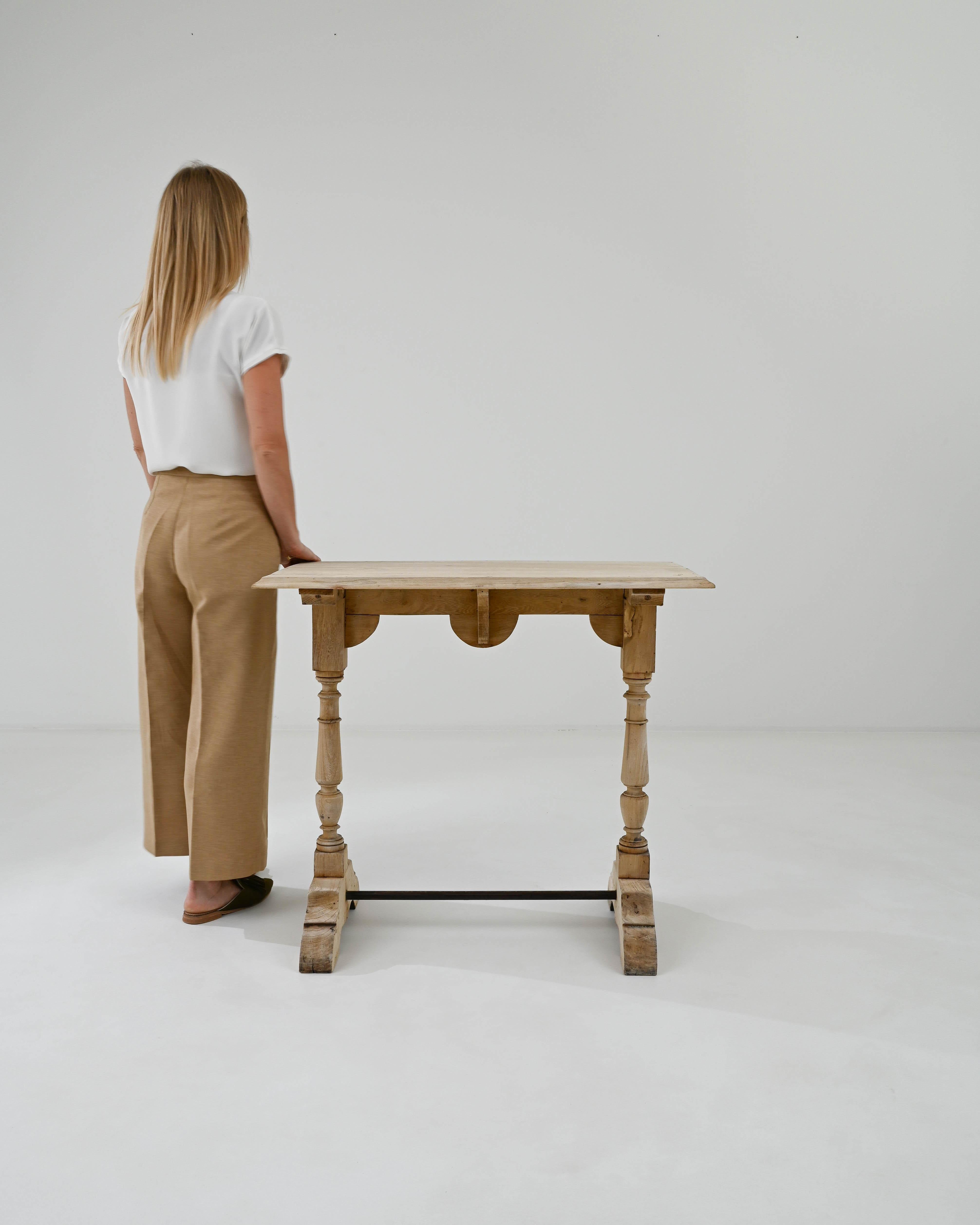 A warm patina gives this wooden console table a homey character. Built in France at the turn of the century, the original finish of the wood has aged over the years to a honeyed polish. The form has an appealing simplicity: a rectangular tabletop