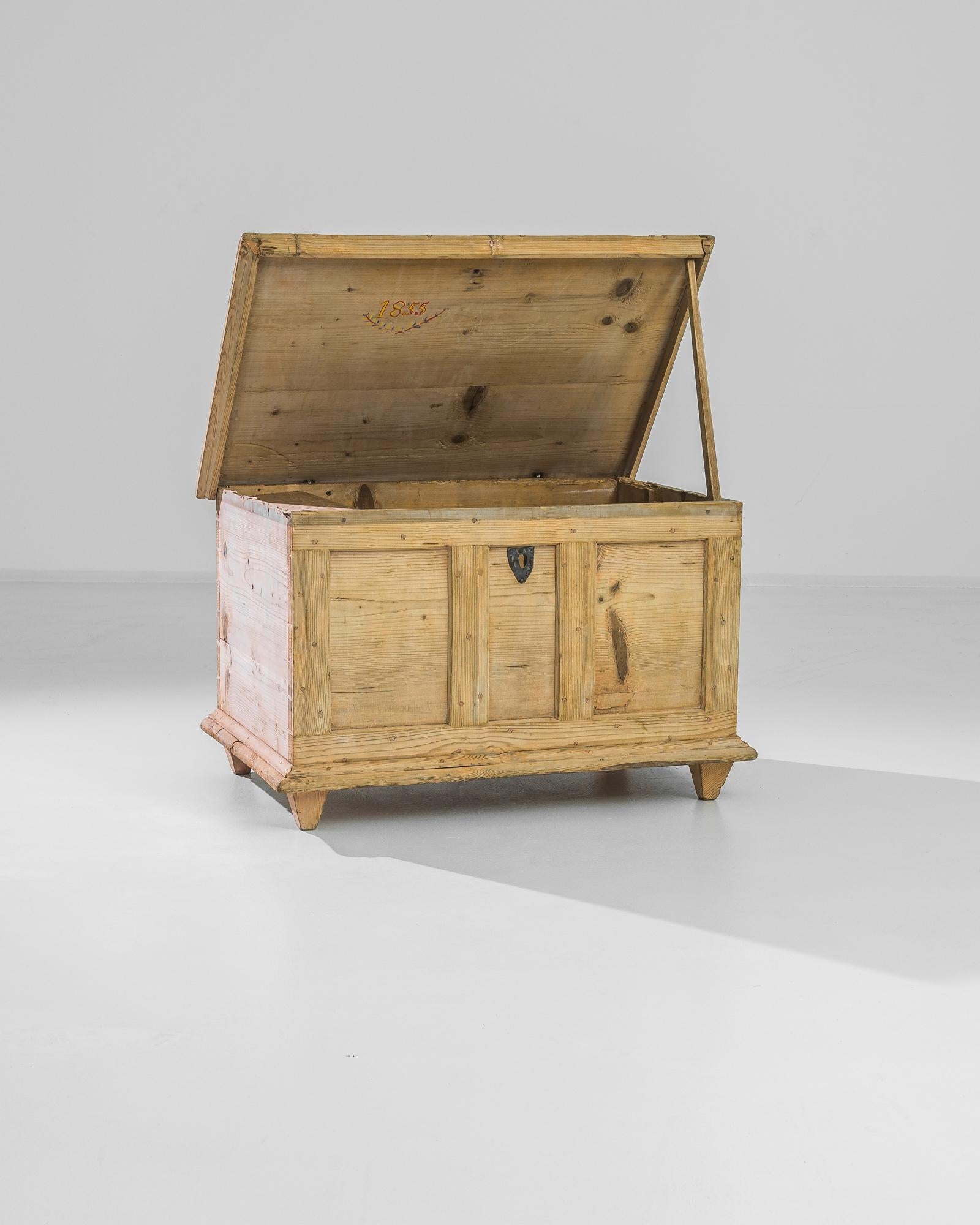 Step back in time with this authentic 1900s French Wooden Trunk, a charming addition to any home decor. Crafted with meticulous attention to detail, this trunk boasts a robust pine wood construction, providing durability and a rustic aesthetic that