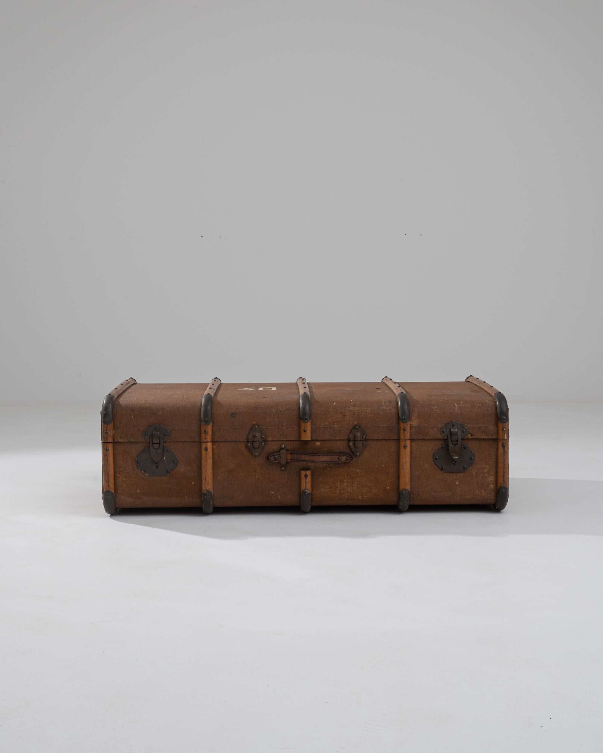 Explore the elegance and historical charm of this 1900s French Wooden Trunk, a quintessential piece from the turn of the century that combines functionality with timeless style. This robust trunk showcases a beautifully aged wooden exterior,