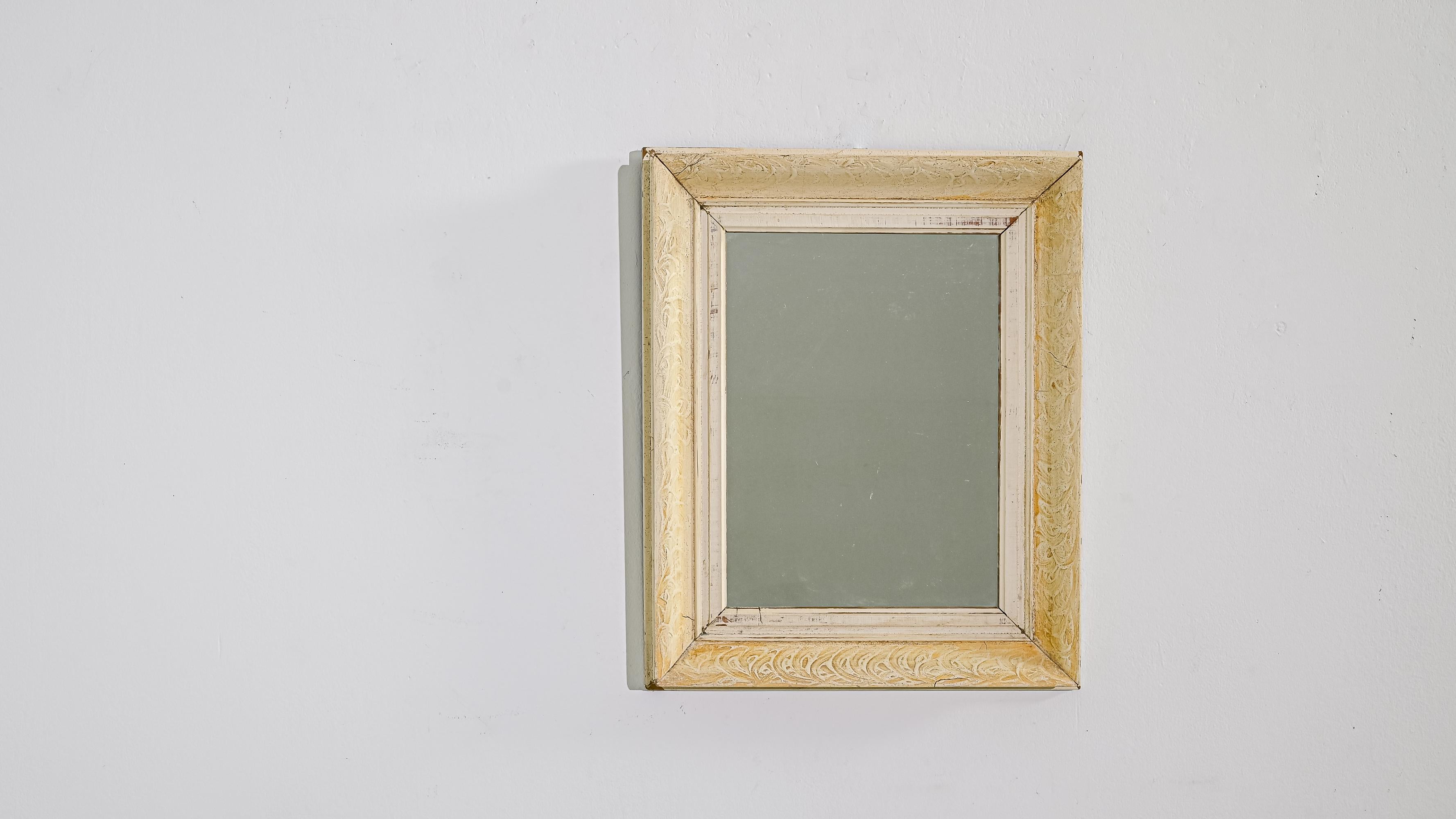 Discover the timeless elegance of our 1900s French Wooden White Patinated Mirror, a true reflection of vintage charm and character. Crafted during the turn of the century, this exquisite piece features a delicately carved wooden frame, adorned with