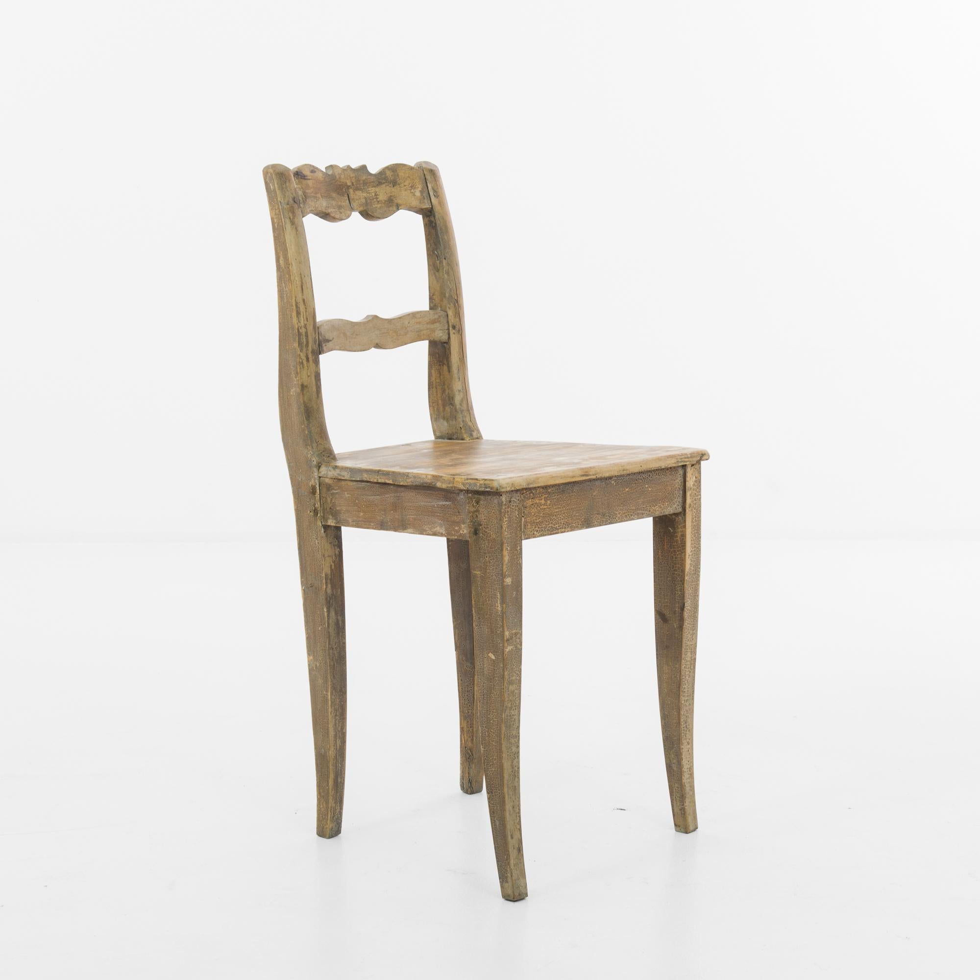 Crafted in the early 1900s, this exquisite German wooden chair epitomizes the timeless elegance and superb craftsmanship of the era. Carved from fine, sturdy wood, likely oak or beech, this chair boasts a classic design that seamlessly blends