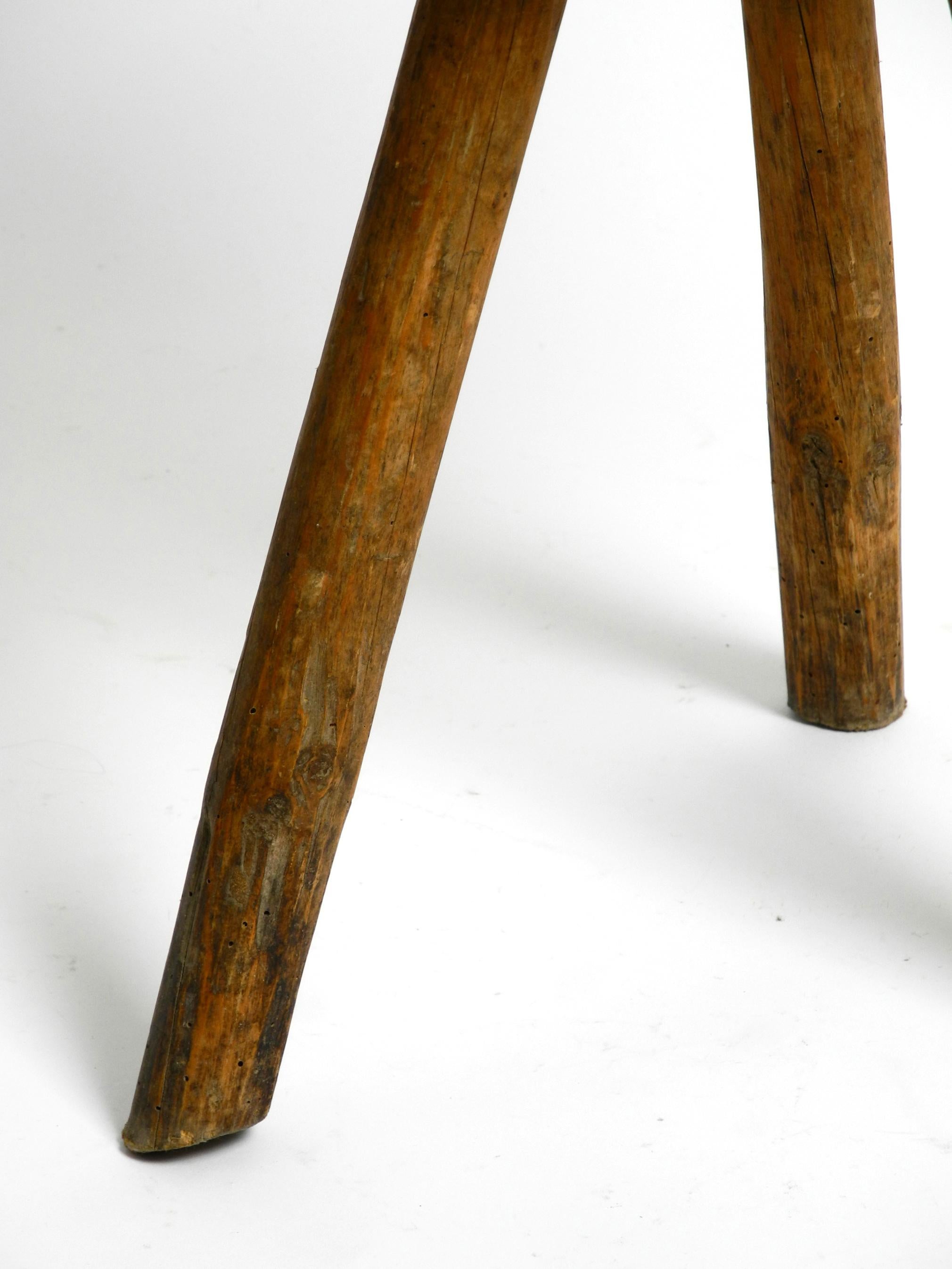1900s hand-carved three-legged solid wood stool with a fantastic patina For Sale 4
