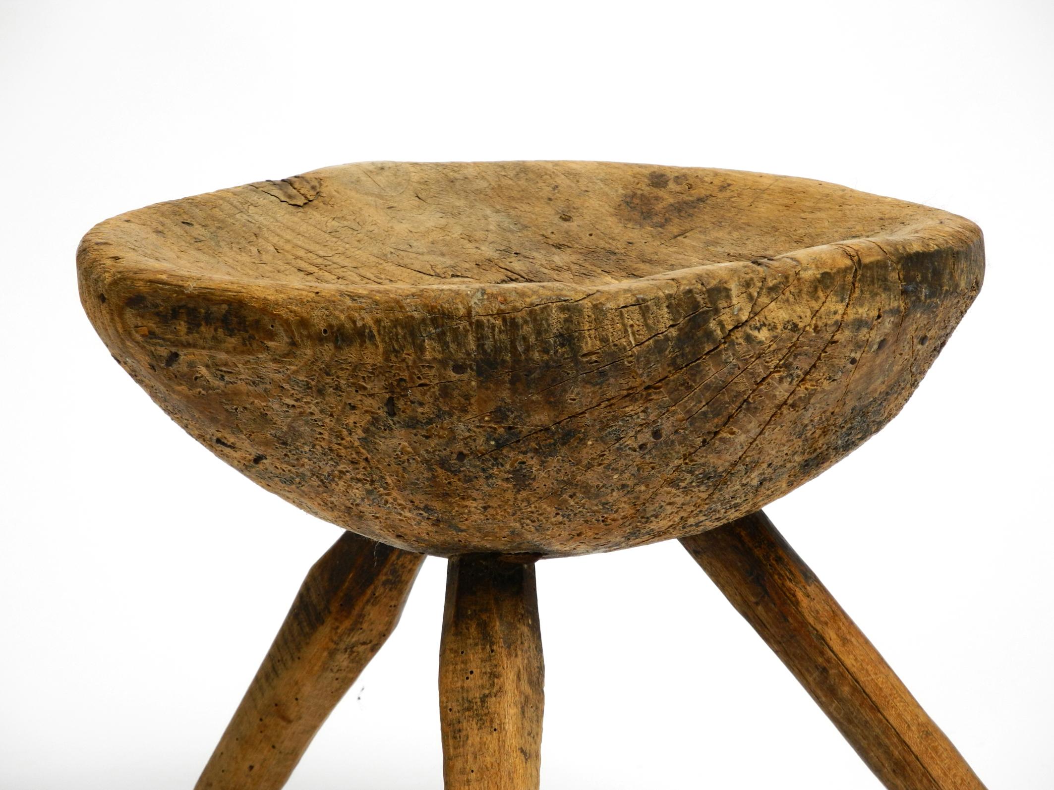1900s hand-carved three-legged solid wood stool with a fantastic patina For Sale 5