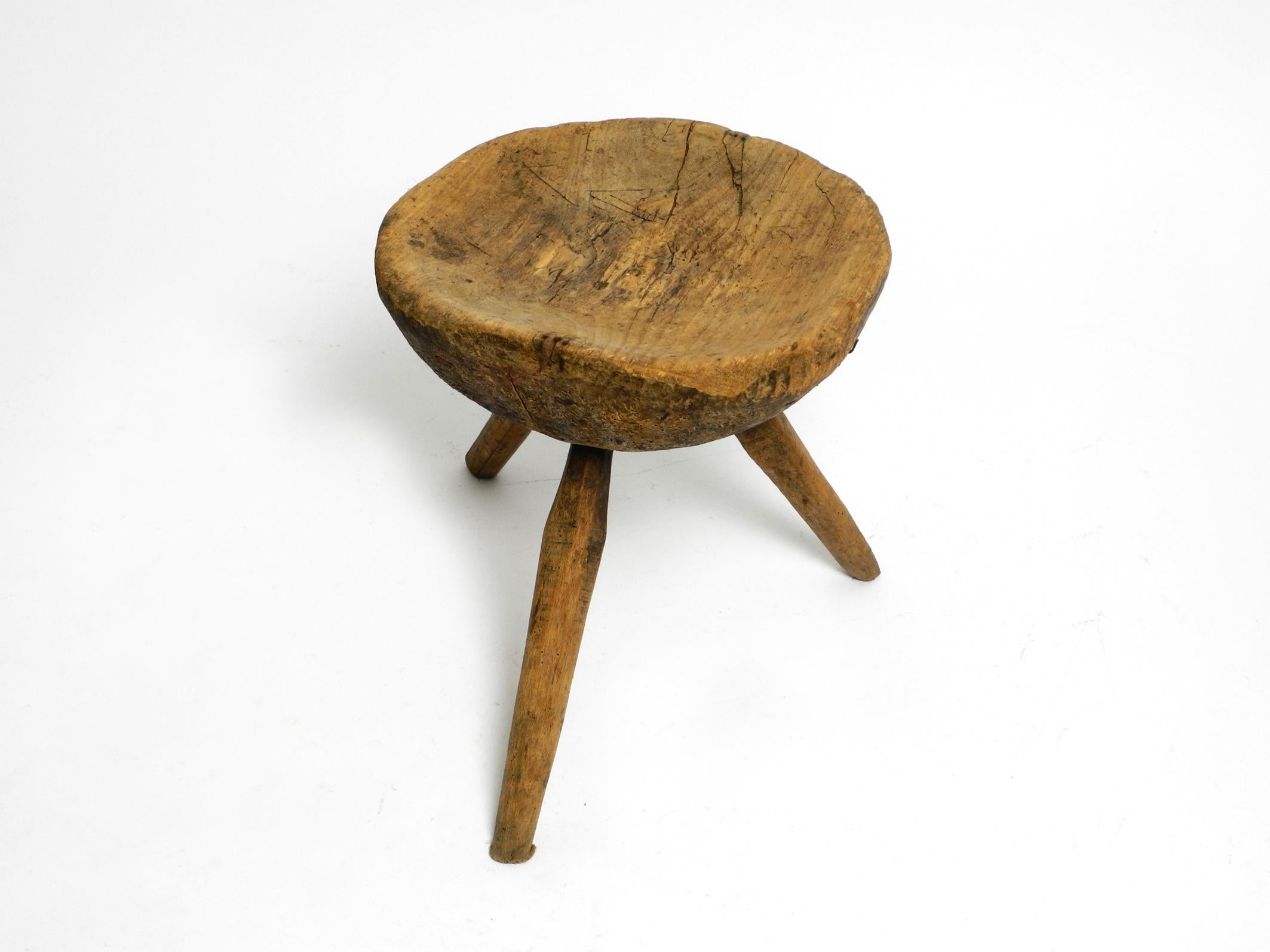 1900s hand-carved three-legged solid wood stool with a fantastic patina For Sale 7