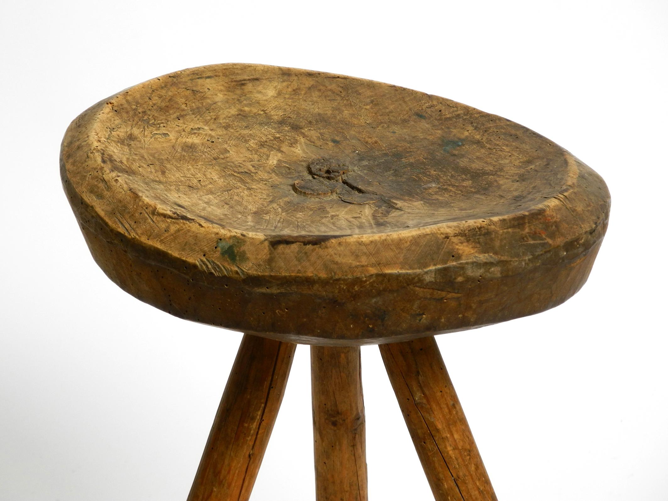 1900s hand-carved three-legged solid wood stool with a fantastic patina For Sale 8