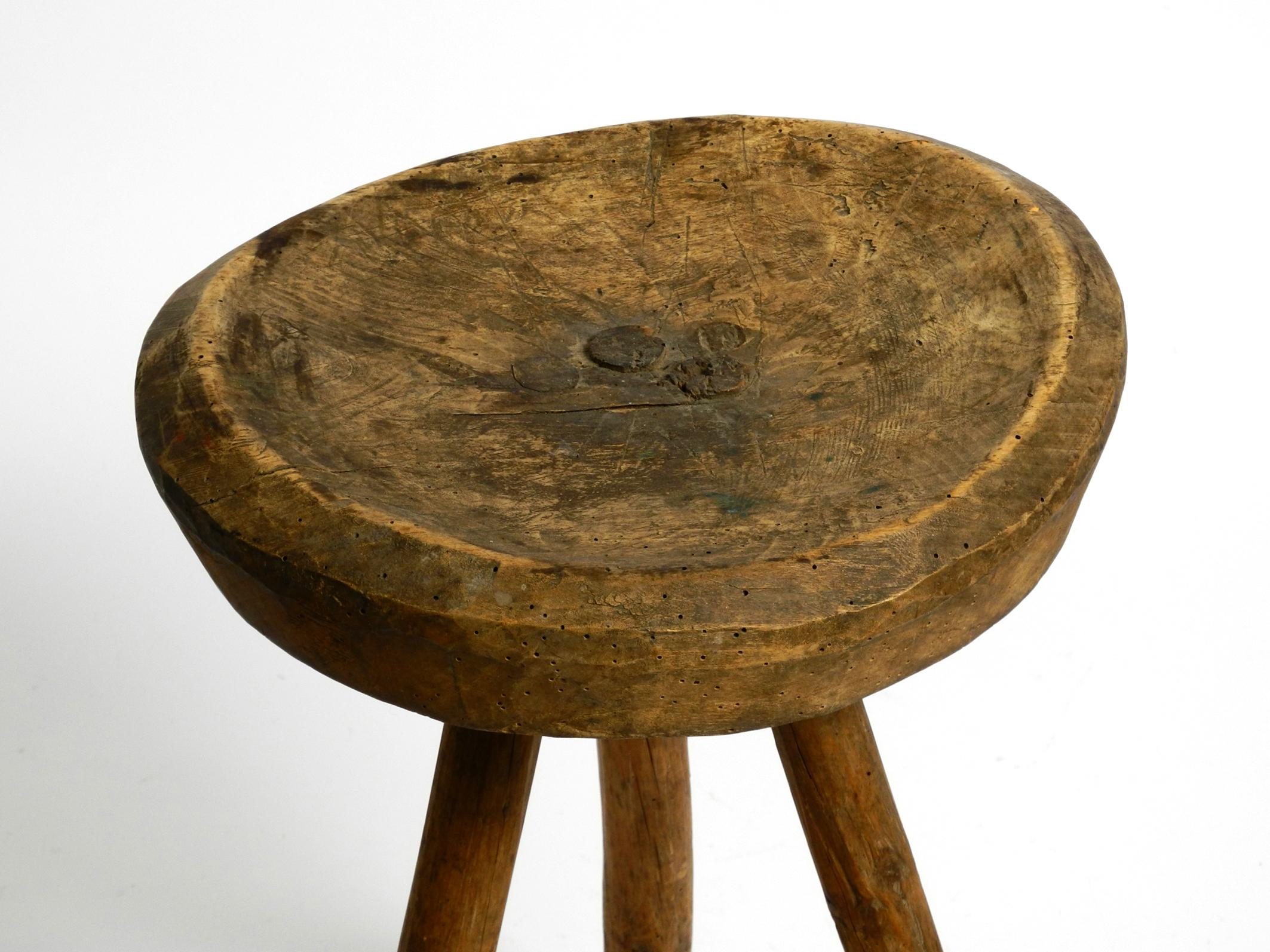 1900s hand-carved three-legged solid wood stool with a fantastic patina For Sale 9