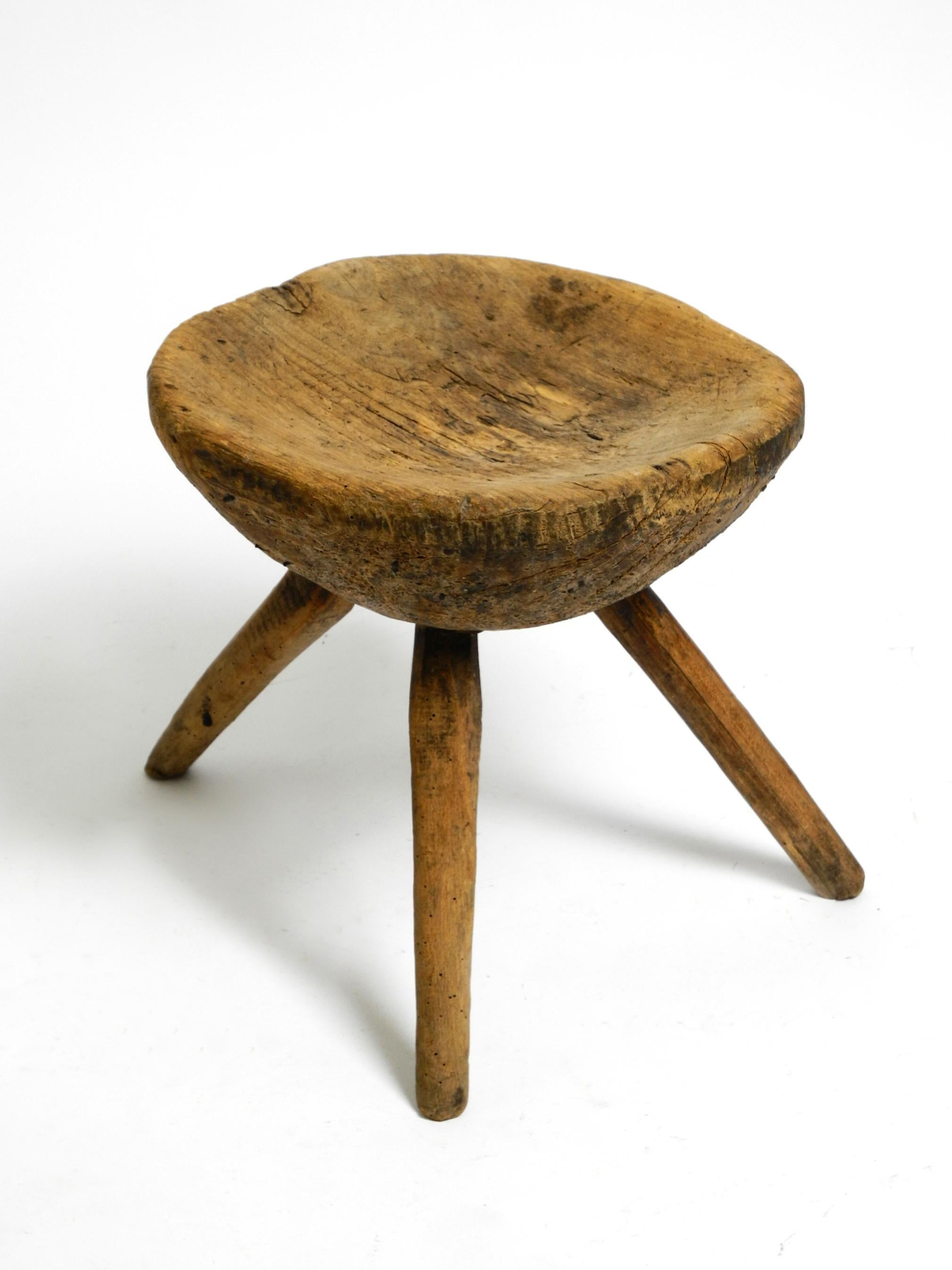 1900s hand-carved three-legged solid wood stool with a fantastic patina For Sale 10