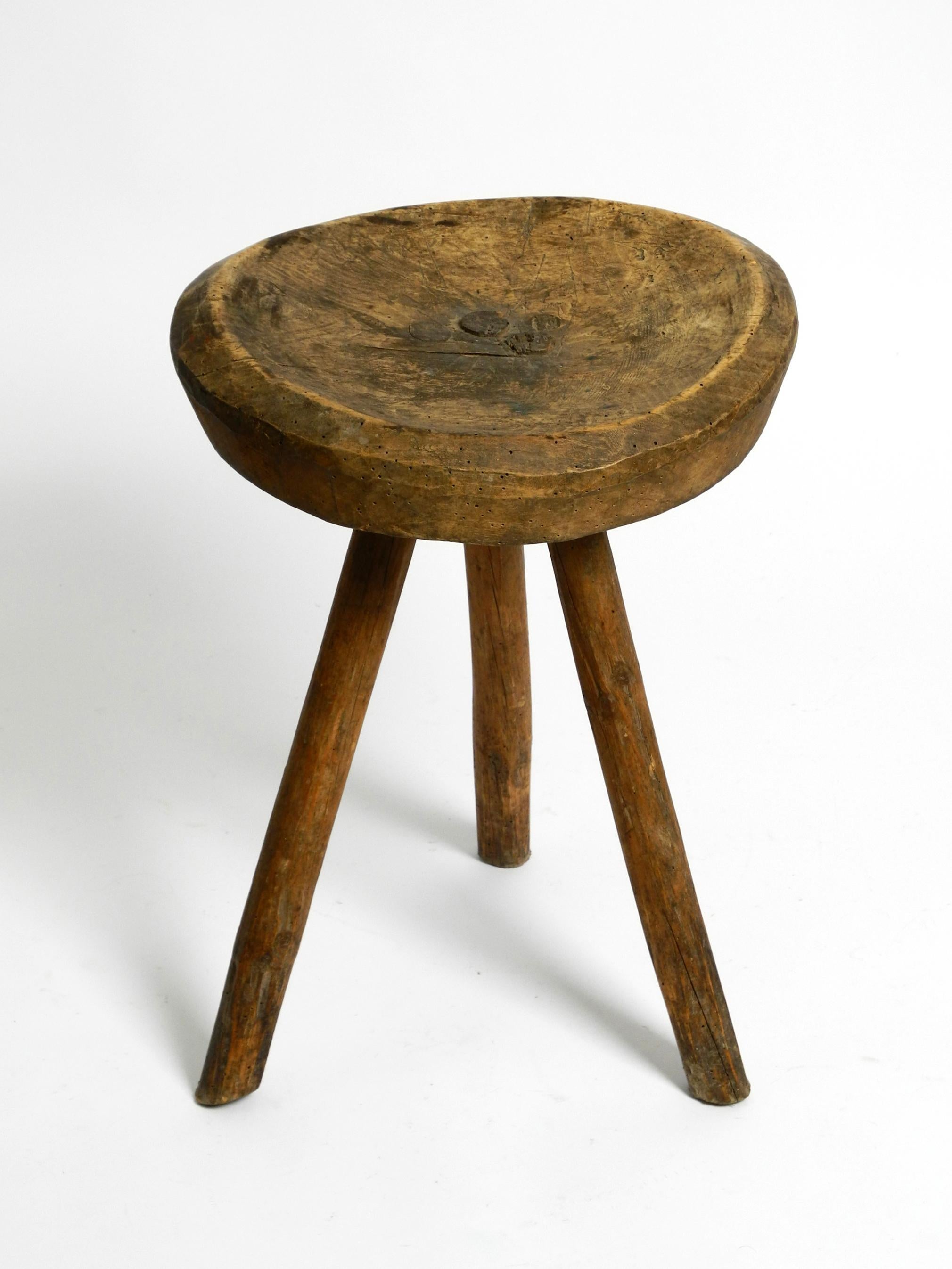 1900s hand-carved three-legged solid wood stool with a fantastic patina For Sale 11